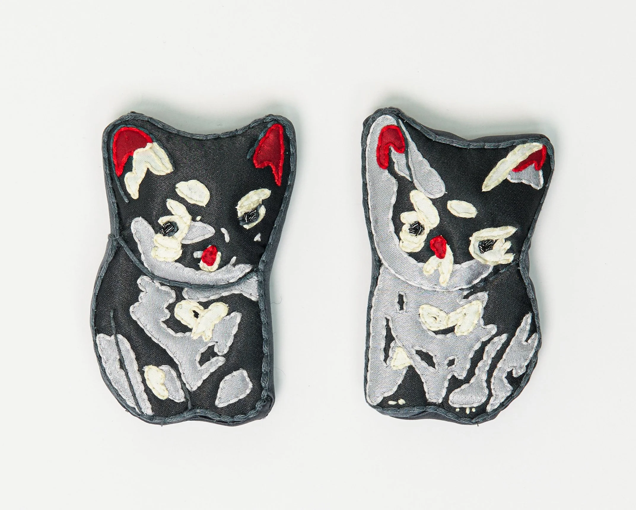"Cheri's Black Cats" (2025), hand-embroidered silk and other textiles, each is 10.5cm x 7cm x 3cm, £450 for the pair