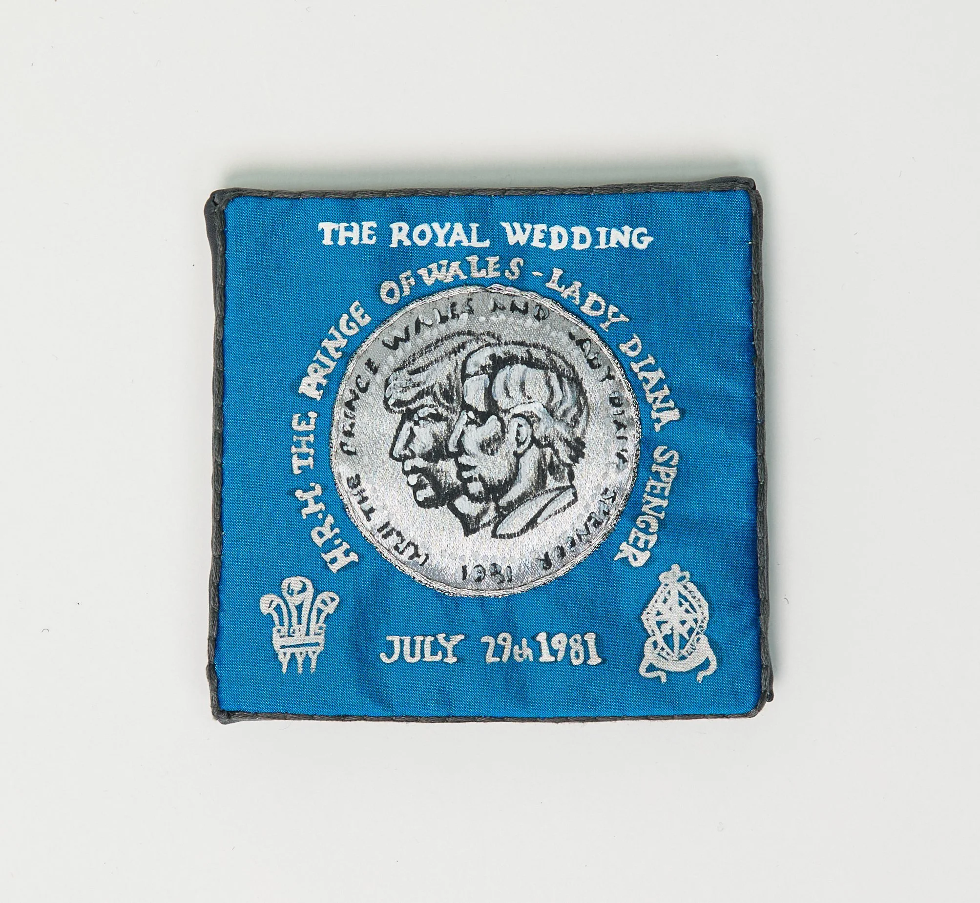 "My Charles and Diana Coin" (2025), hand-embroidered and hand-painted silk and other textiles, 10.5cm x 11cm x 2cm, £150