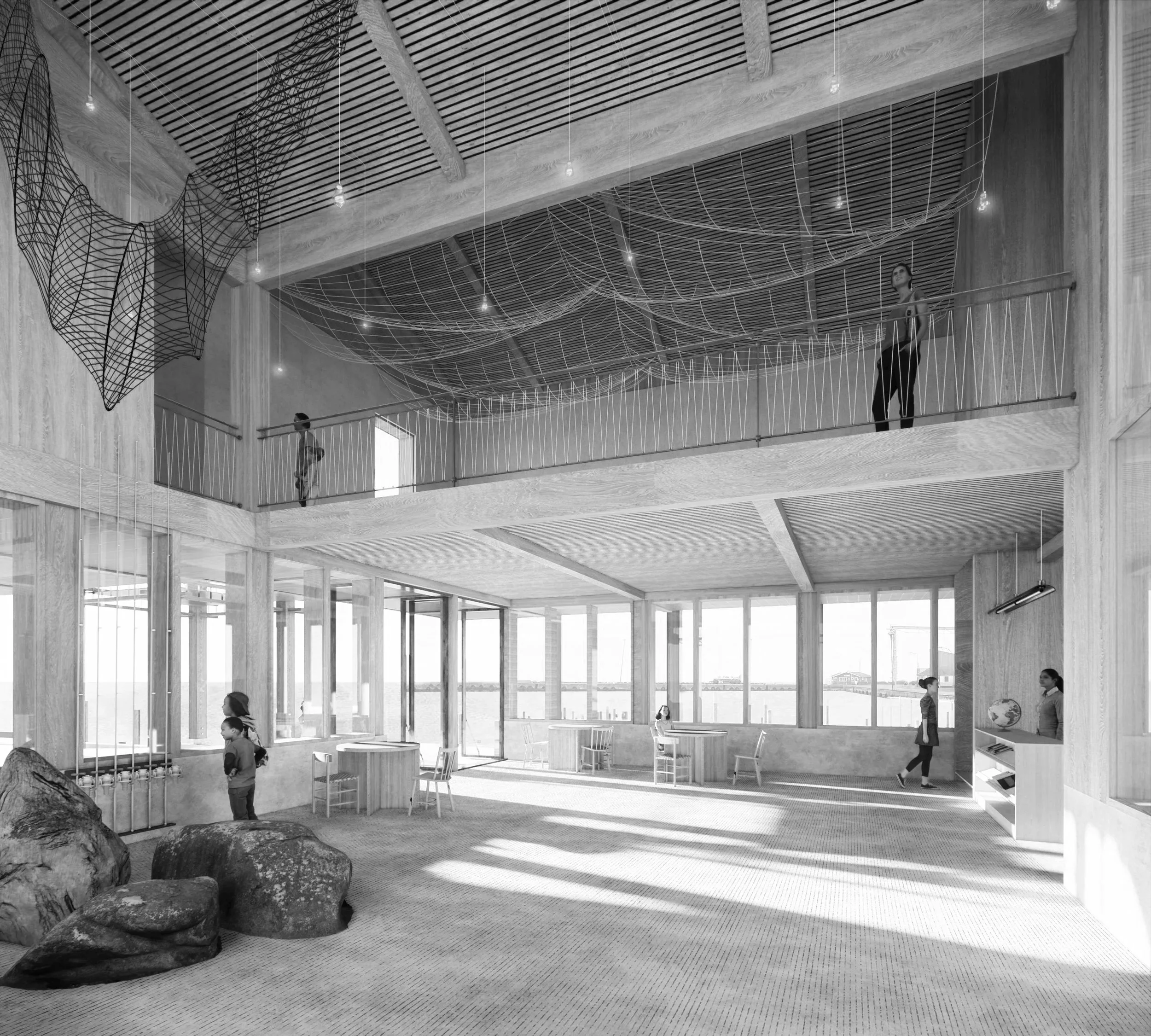 Interior of a modern building with large windows, a double-height space, wooden finishes, and a mezzanine level with people walking and standing. There are decorative hanging wire structures on the ceiling, and natural light is flooding the space.