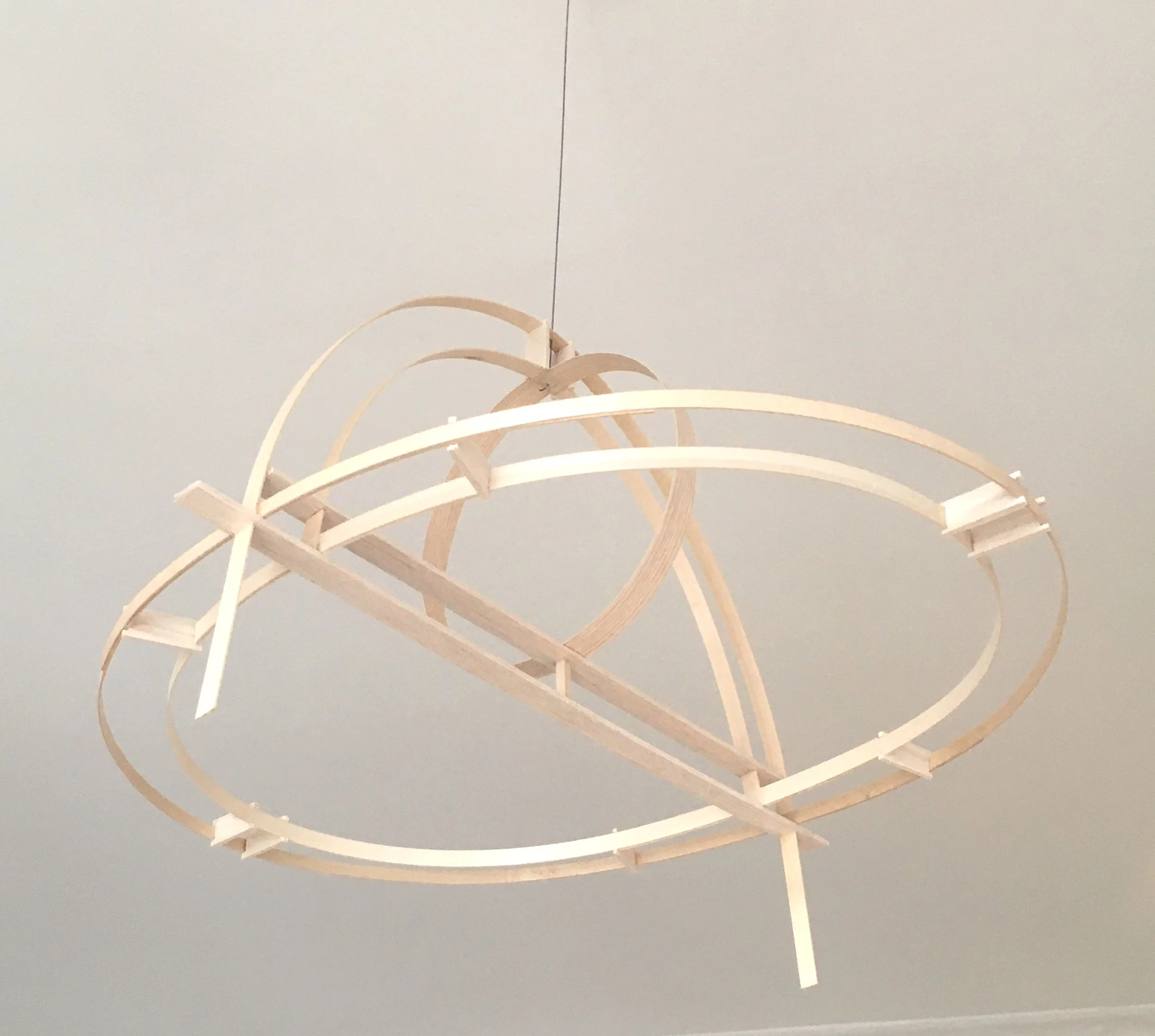 A modern chandelier with wooden curved arms, hanging from the ceiling.