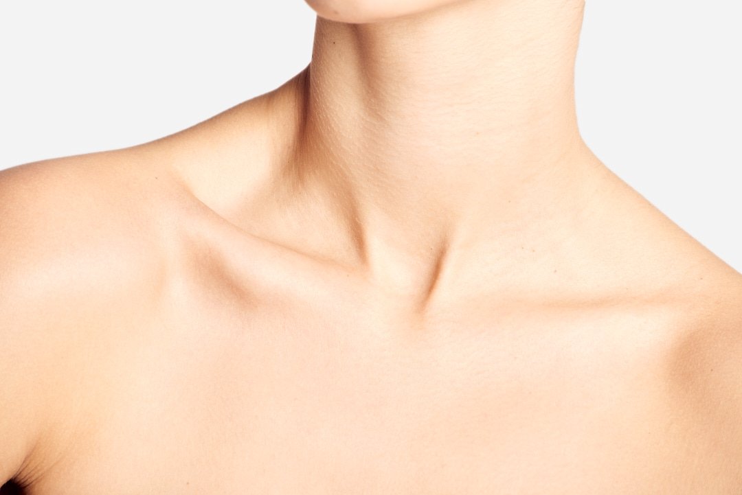 Close-up of a woman's neck and shoulders with smooth skin.