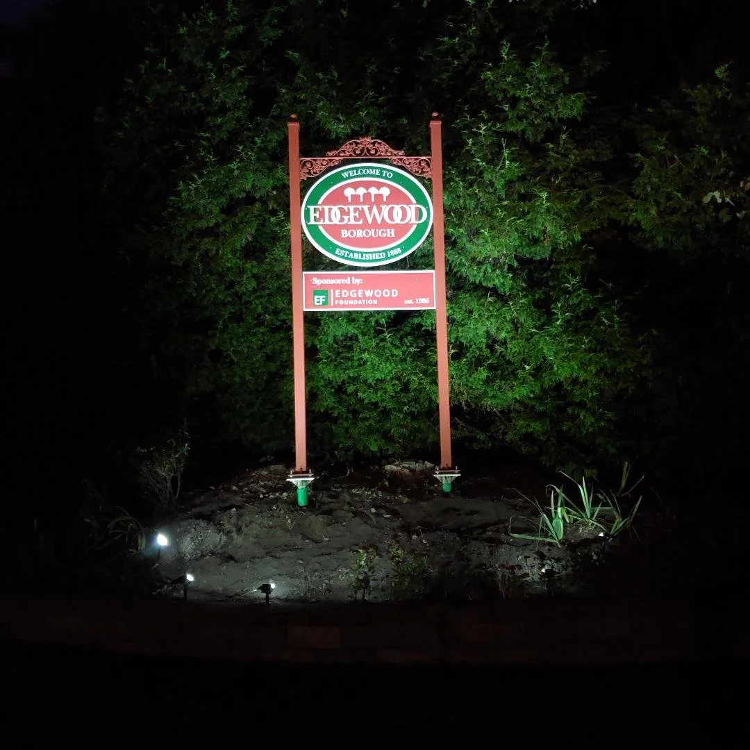 The new sign lit up at night by solar lights
