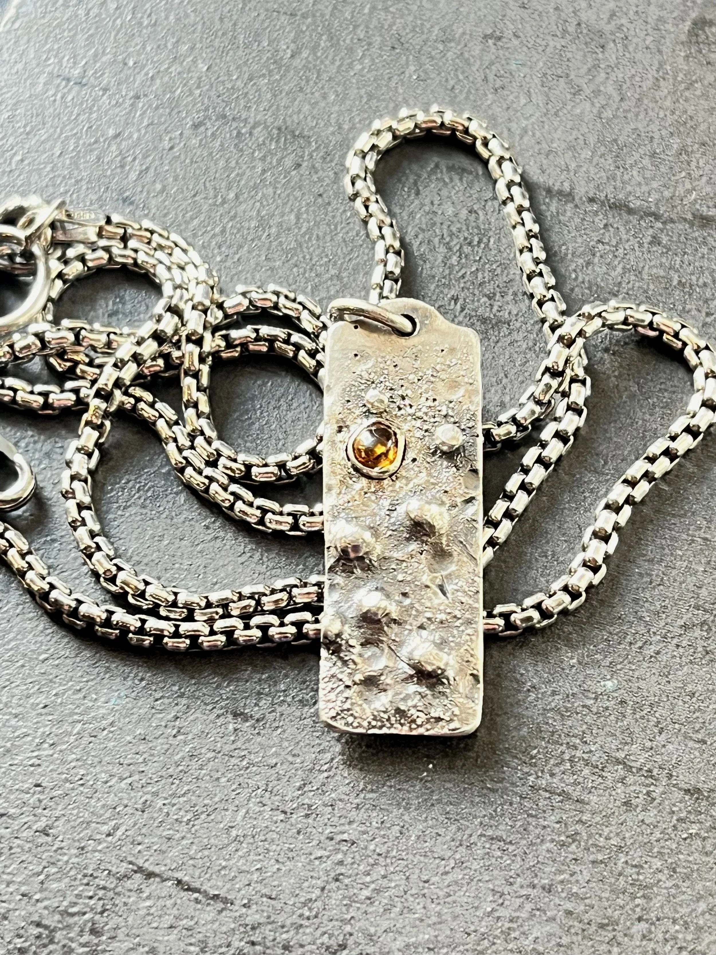 Vesper Peak garnet (USA) mined made into a pendant, celebrating a son. 