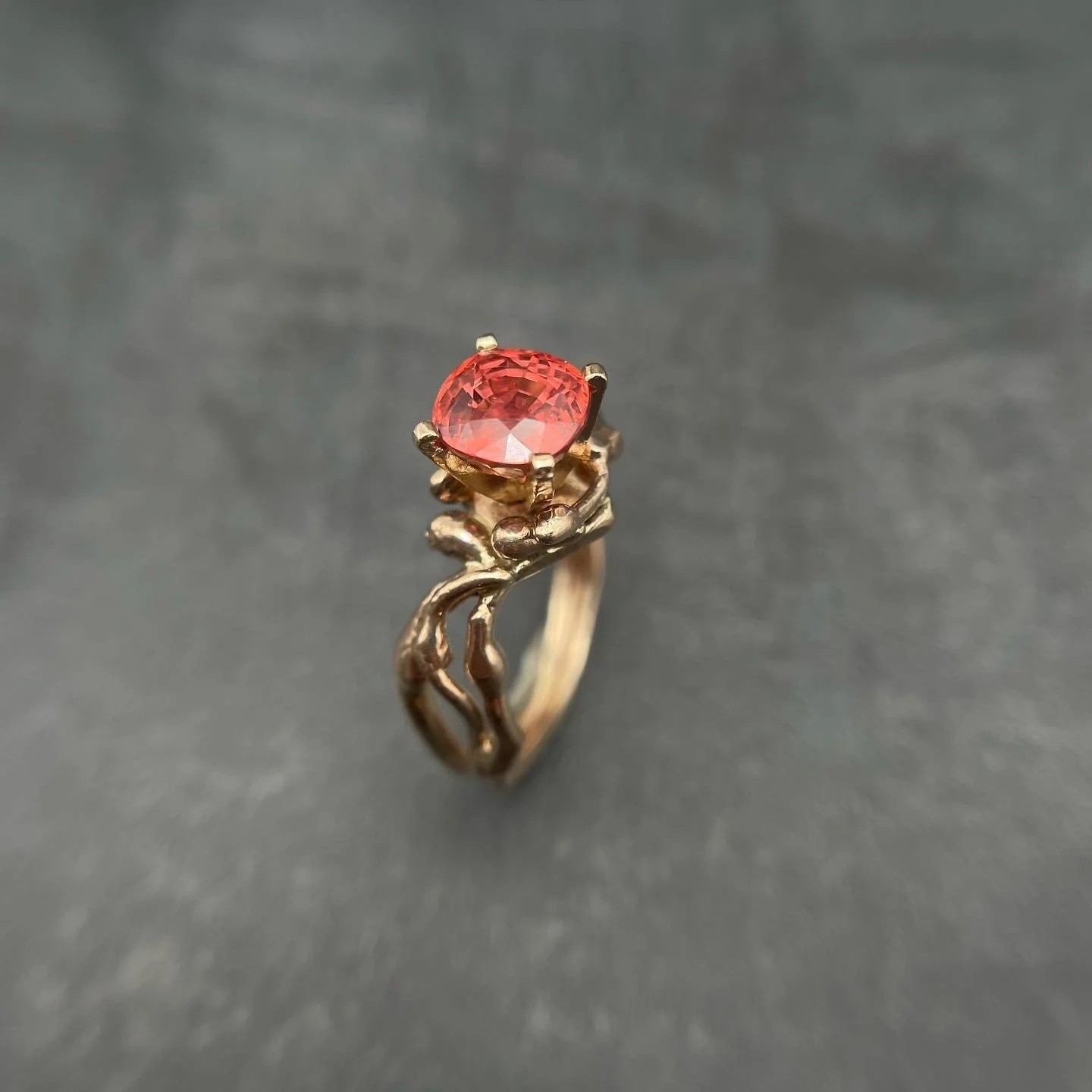 Padparadsha Sapphire set in multiple14k yellow gold "Earthen" bands