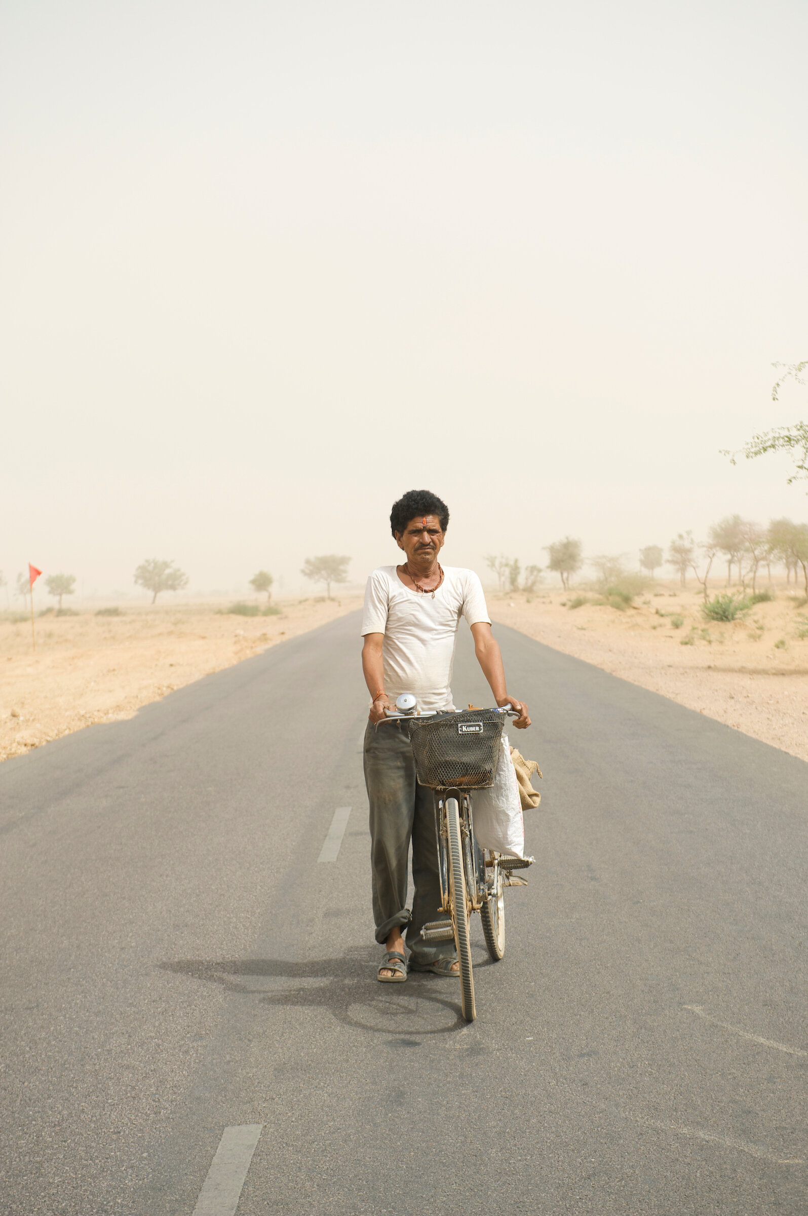  Day laborer commuting in a sandstorm - Rajasthan, India 