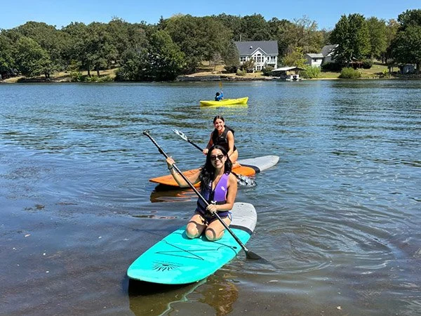 Students wakeboarding at the lake during Freshman Escape