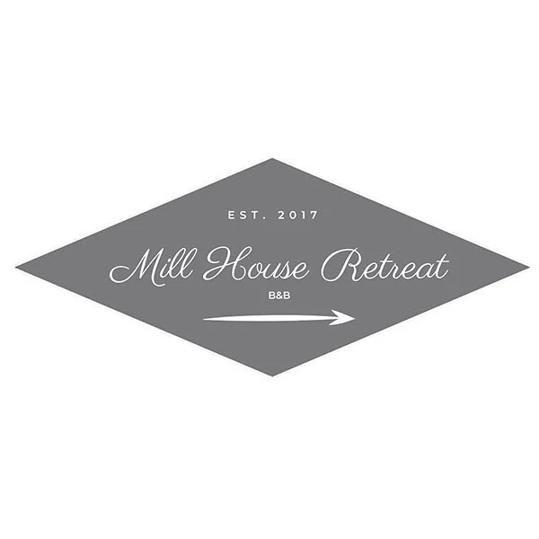 Gray diamond-shaped logo with text "Mill House Retreat" and "Established 2017," featuring an arrow pointing right.