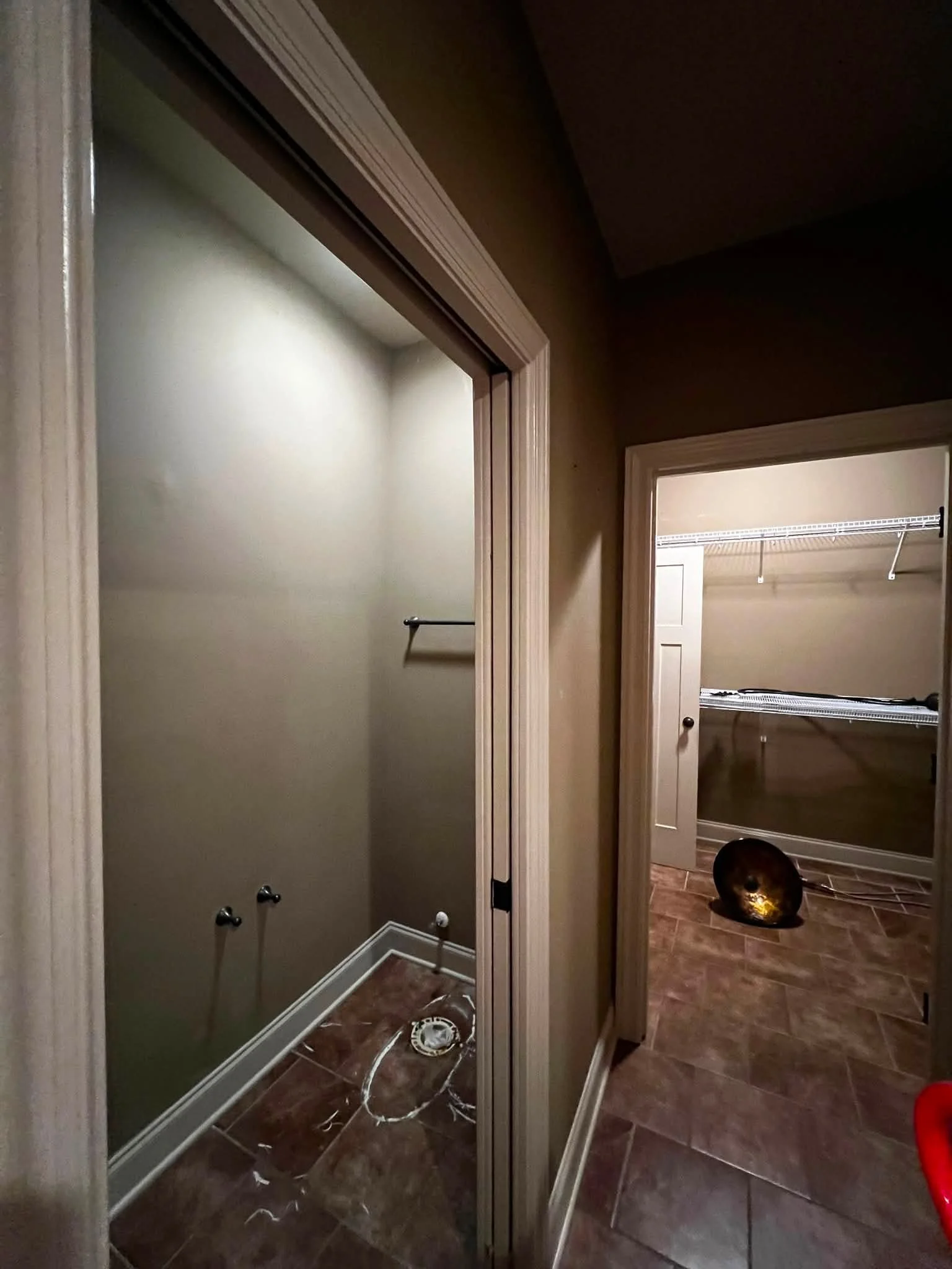 View of a bathroom vanity with no sink, and a walk-in closet with wire shelving in the background.