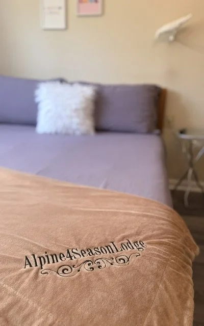Drift into comfort with plush four-season bedding, soft textures, and cozy Catskills charm designed for restful mountain escapes and peaceful nights year-round.
