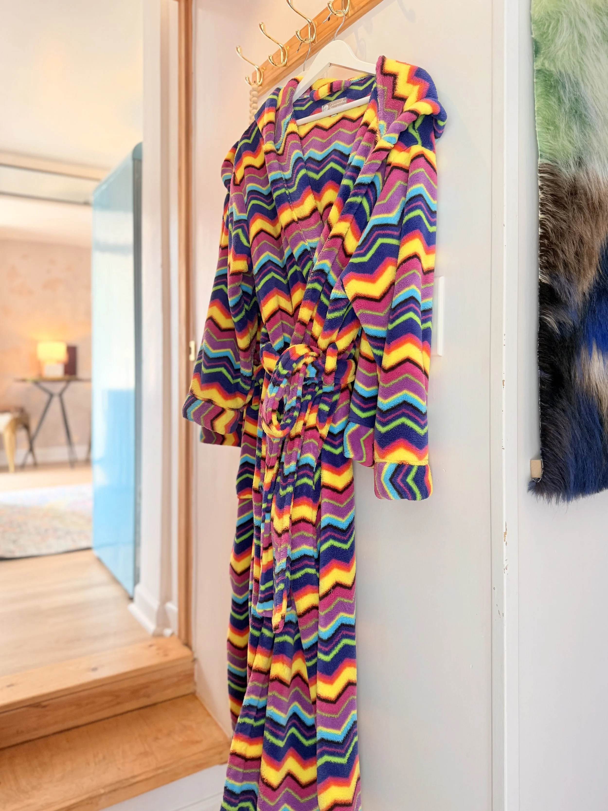 🌈 A vibrant patterned bathrobe adds a playful splash of color to your stay at Alpine Four Season Lodge.