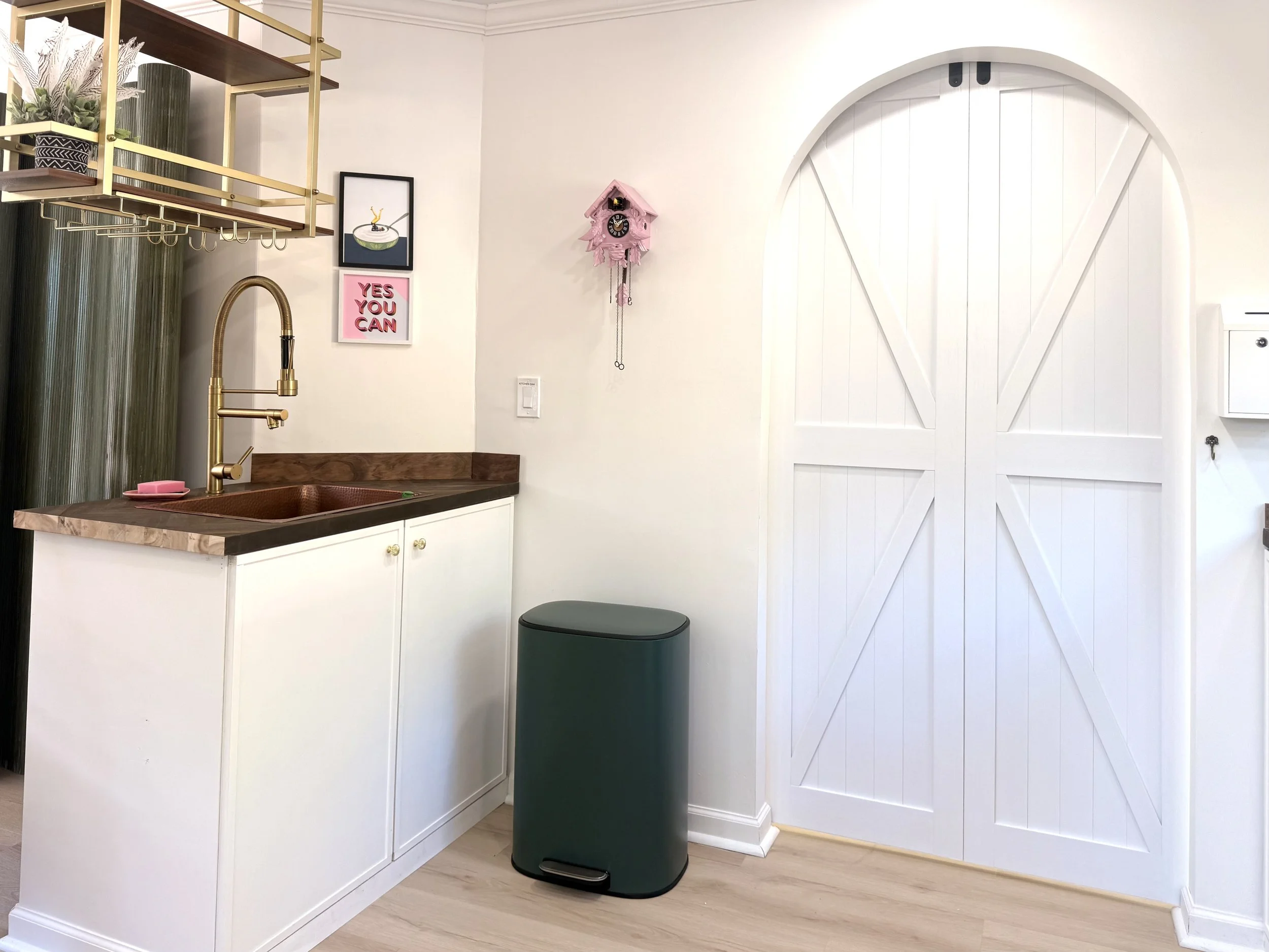 🚪 Modern kitchen counter with a designer copper sink, stylish barn door, and thoughtful details that make this apartment feel like home. 