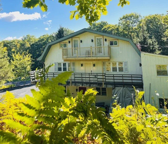 The apartment is nestled in the attic space on the third level of the property, offering a cozy retreat with picturesque views of the forest on the back portion of the property. A bonus: It has it's own, private balcony.