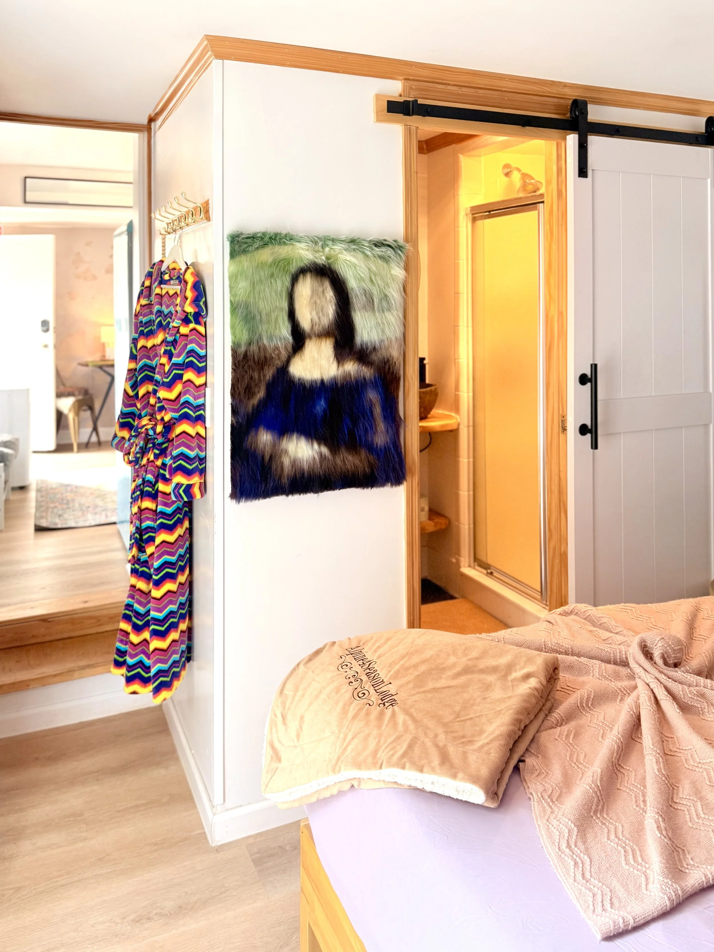 🛏️ A cozy bedroom, colorful artwork and a newly renovated bathroom create a relaxing retreat at Alpine Four Season Lodge.