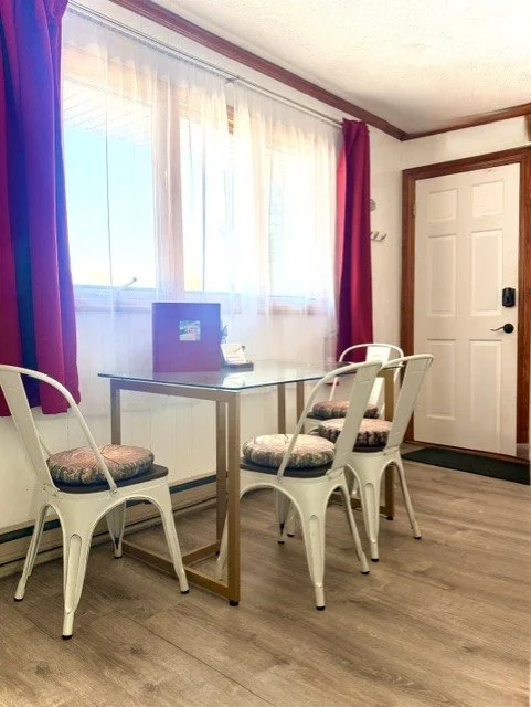 Bright and cozy dining nook with natural light and relaxing Catskills charm — perfect for morning coffee, shared meals, or planning your next mountain adventure.