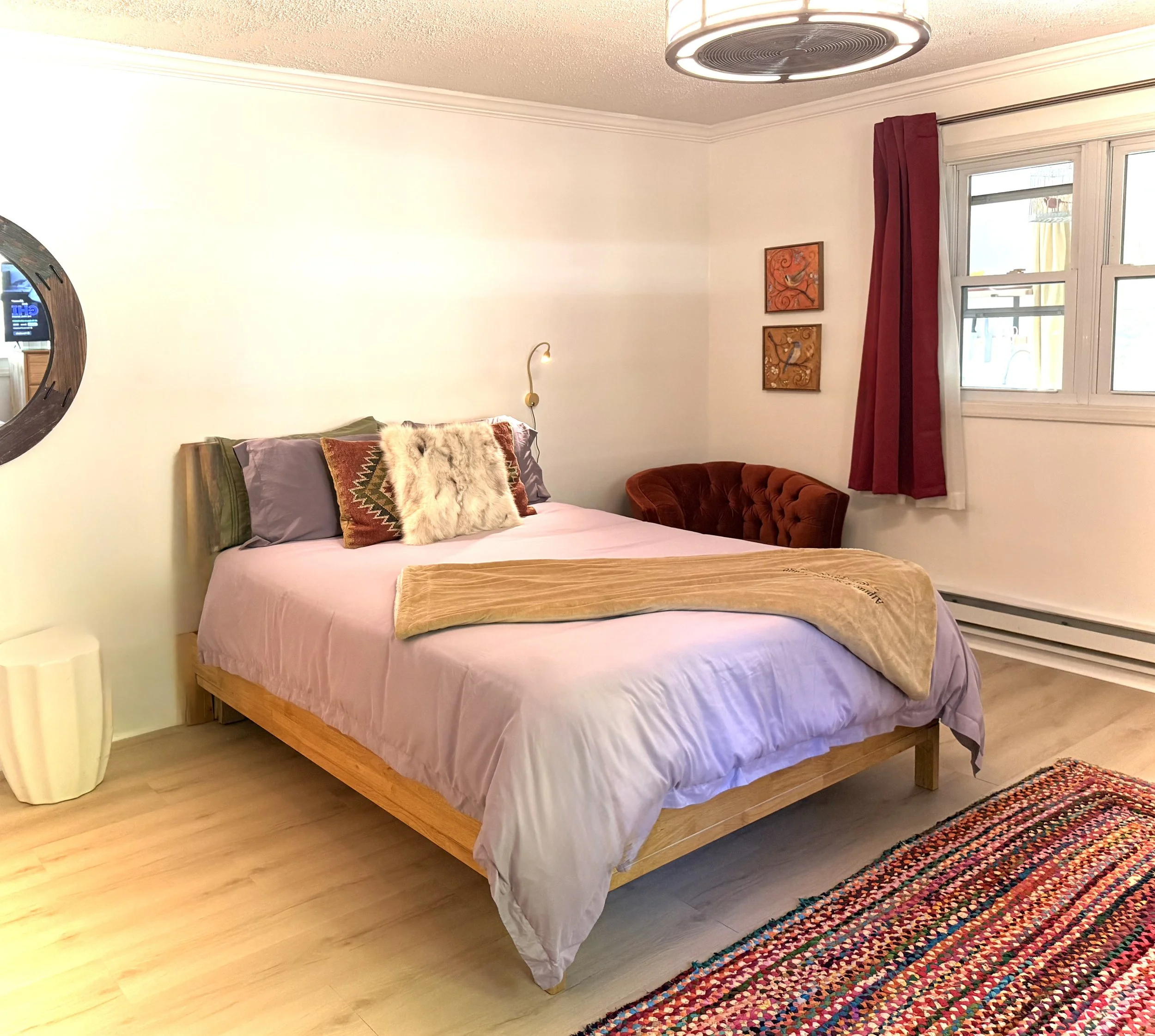 Spacious king bedroom with plush bedding, warm accents, and a peaceful atmosphere perfect for relaxing after Catskills adventures. 