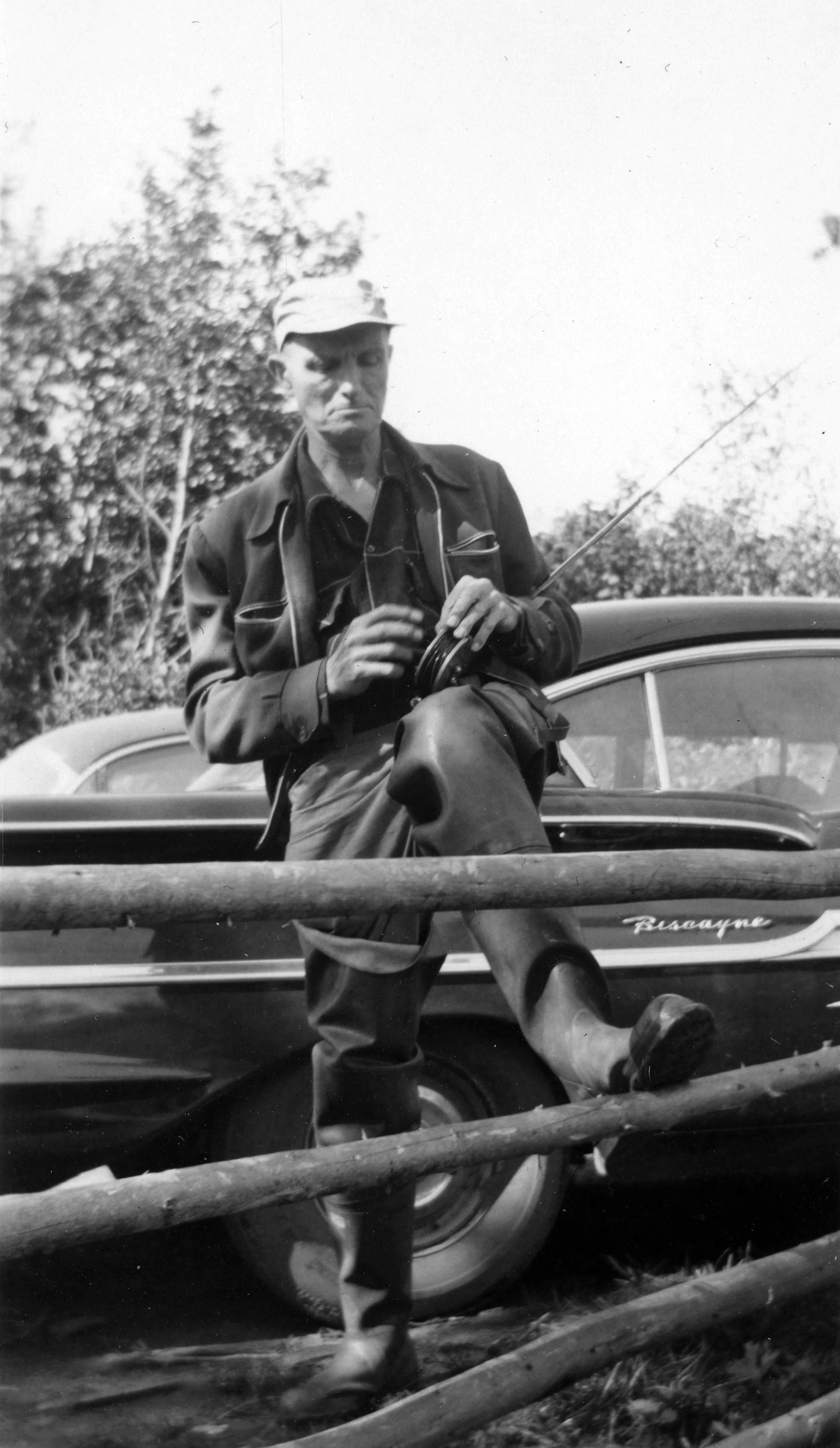 Jim (grandfather) setting up his salmon rod 1942.jpg