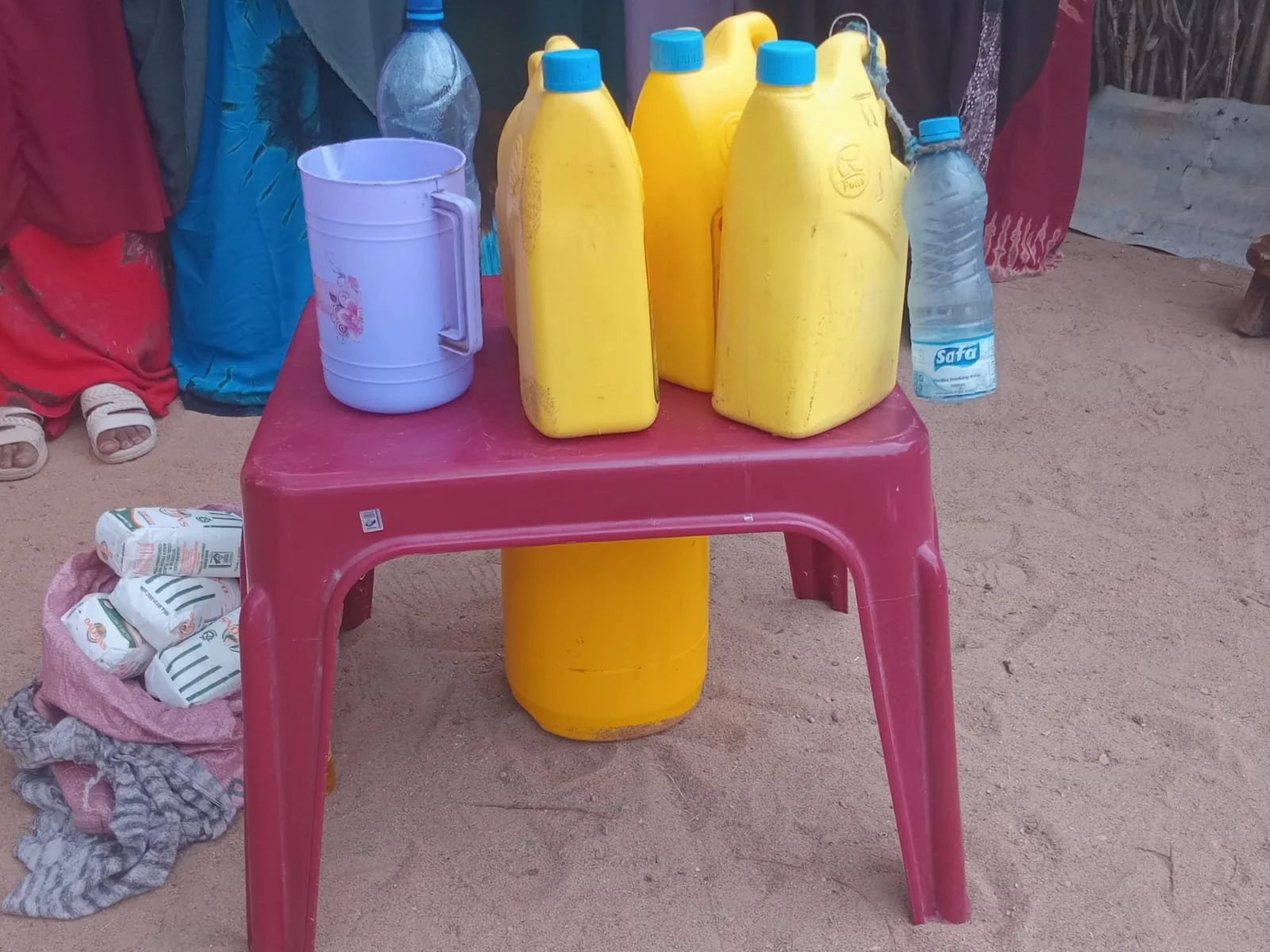 Mogay Stock - milk containers and some packets of unga - maize floor.jpg