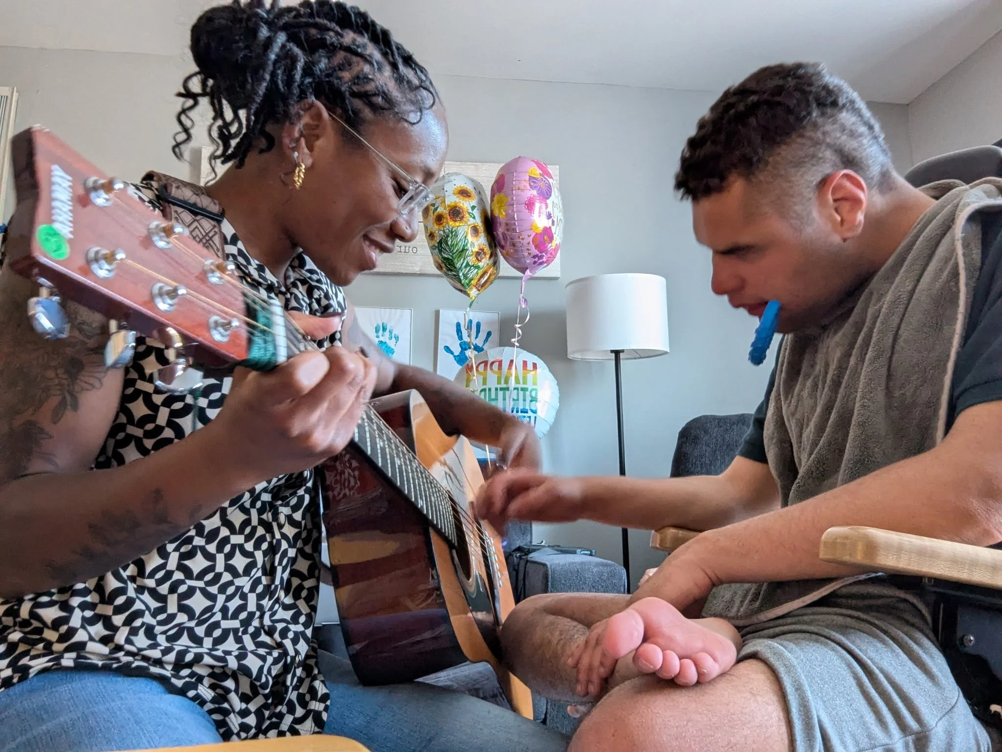 🥉 3rd Place — Mellany Gomez, 
Owner of Melodic Goals LLC, pictured mid-session with client AJ — a moment of connection through music therapy.