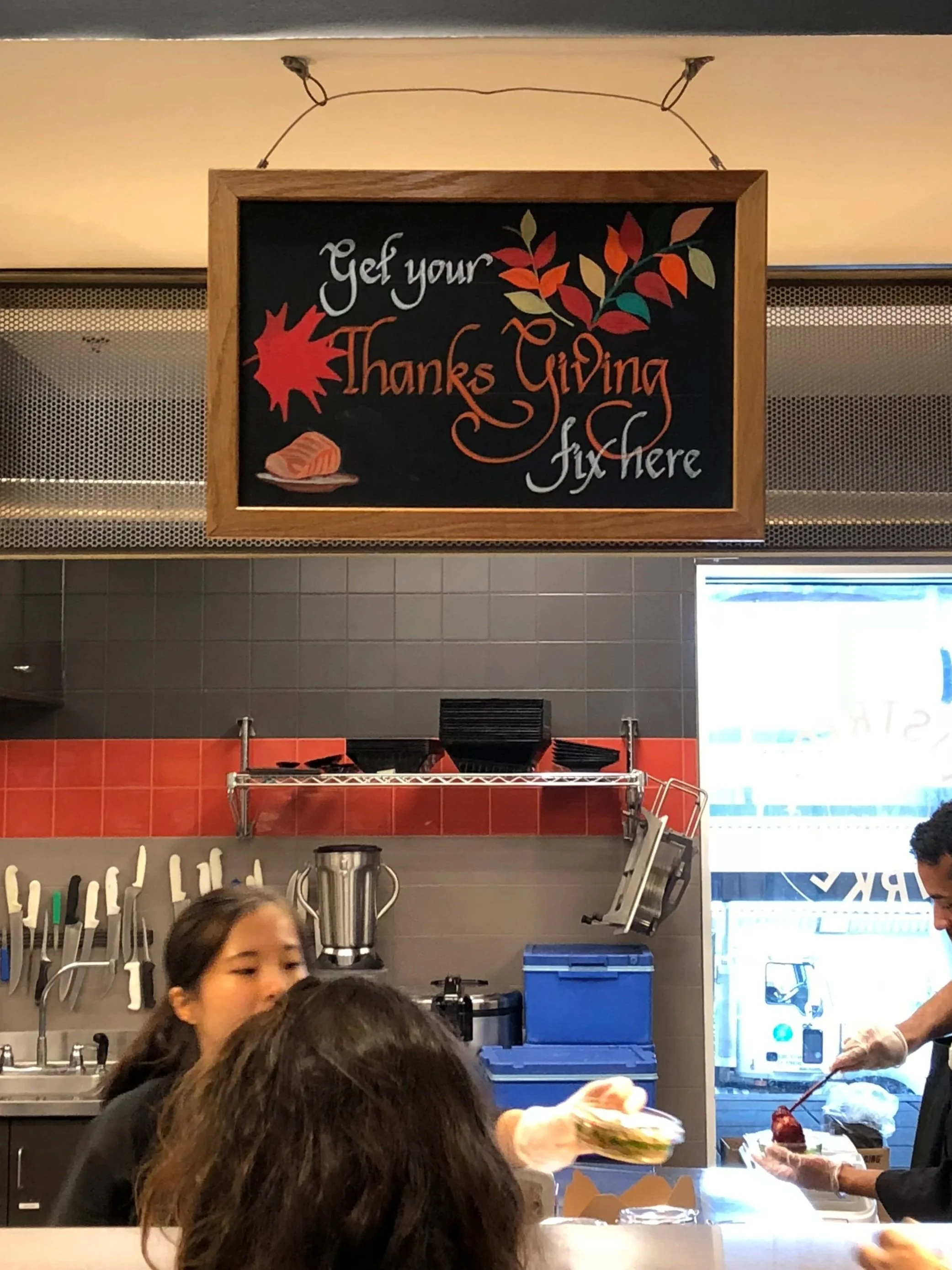 Seasonal chalkboard signage design with hand-drawn typography and autumn illustrations, created for a café environment.