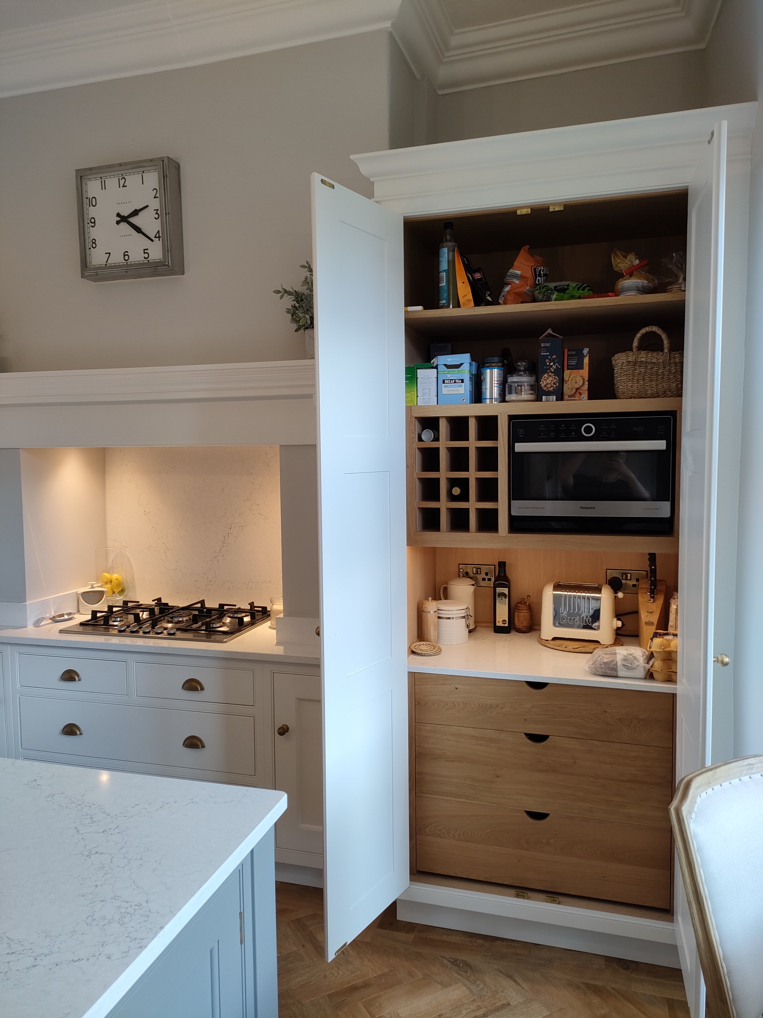 small wine rack sat inside a larder unit