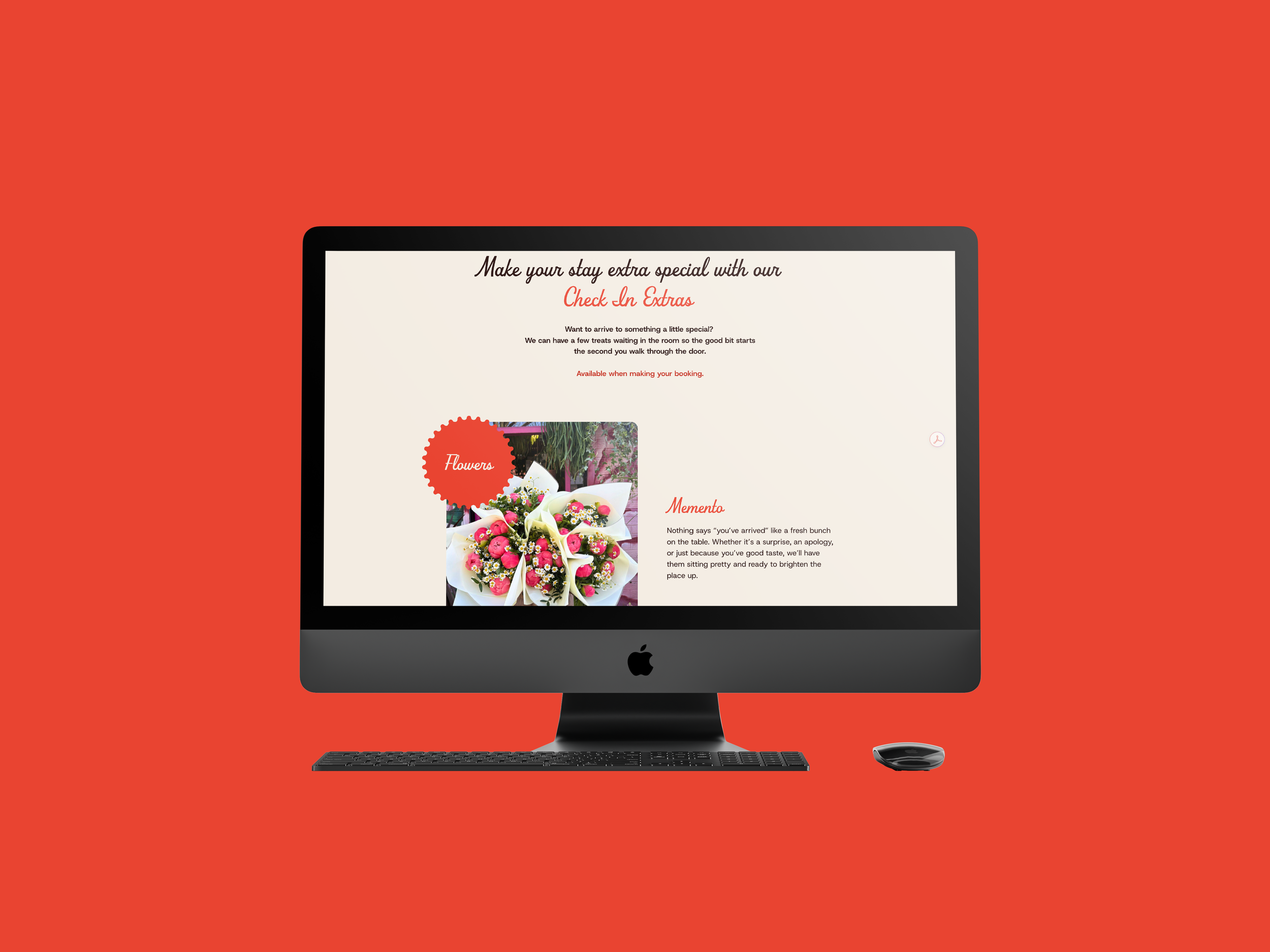 Apple iMac computer displaying a webpage about flower arrangements, with a keyboard and mouse on a red background.