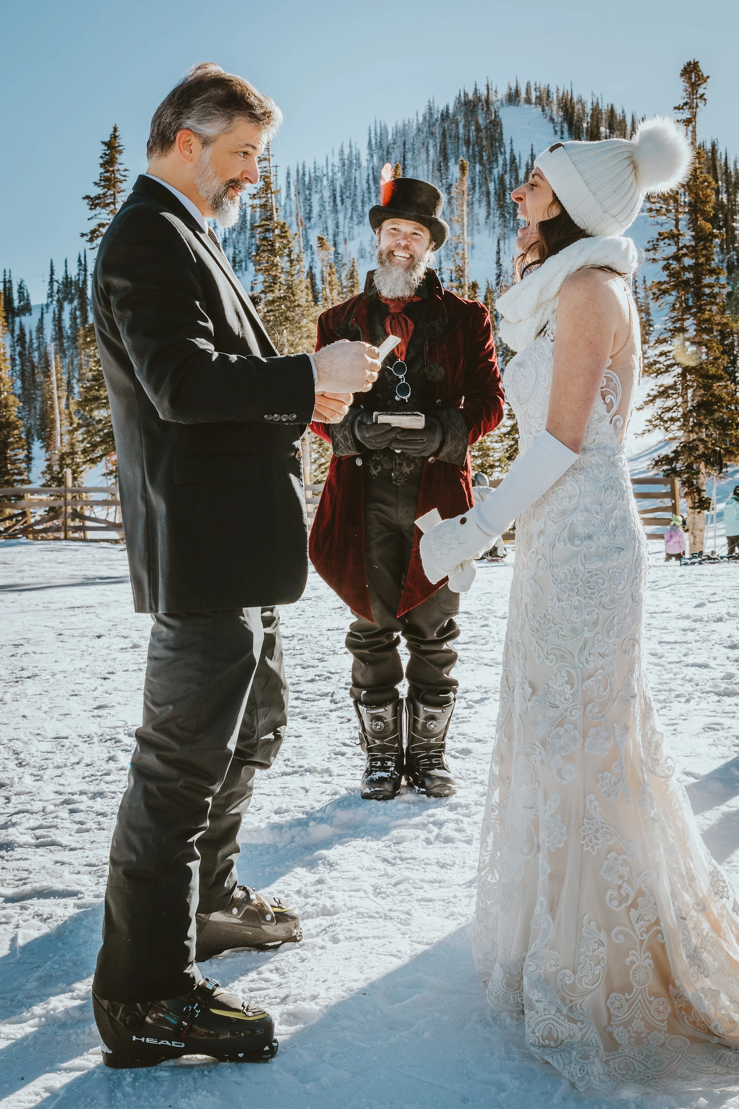 Bride and Groom saying vows during ceremony at Monarch Mountain in Salida, CO. Winter Wedding.