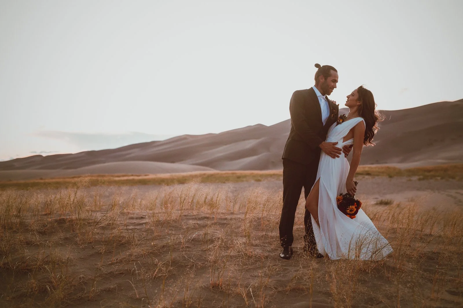 Bride and groom at the Sand Dunes National Park at sunset.
