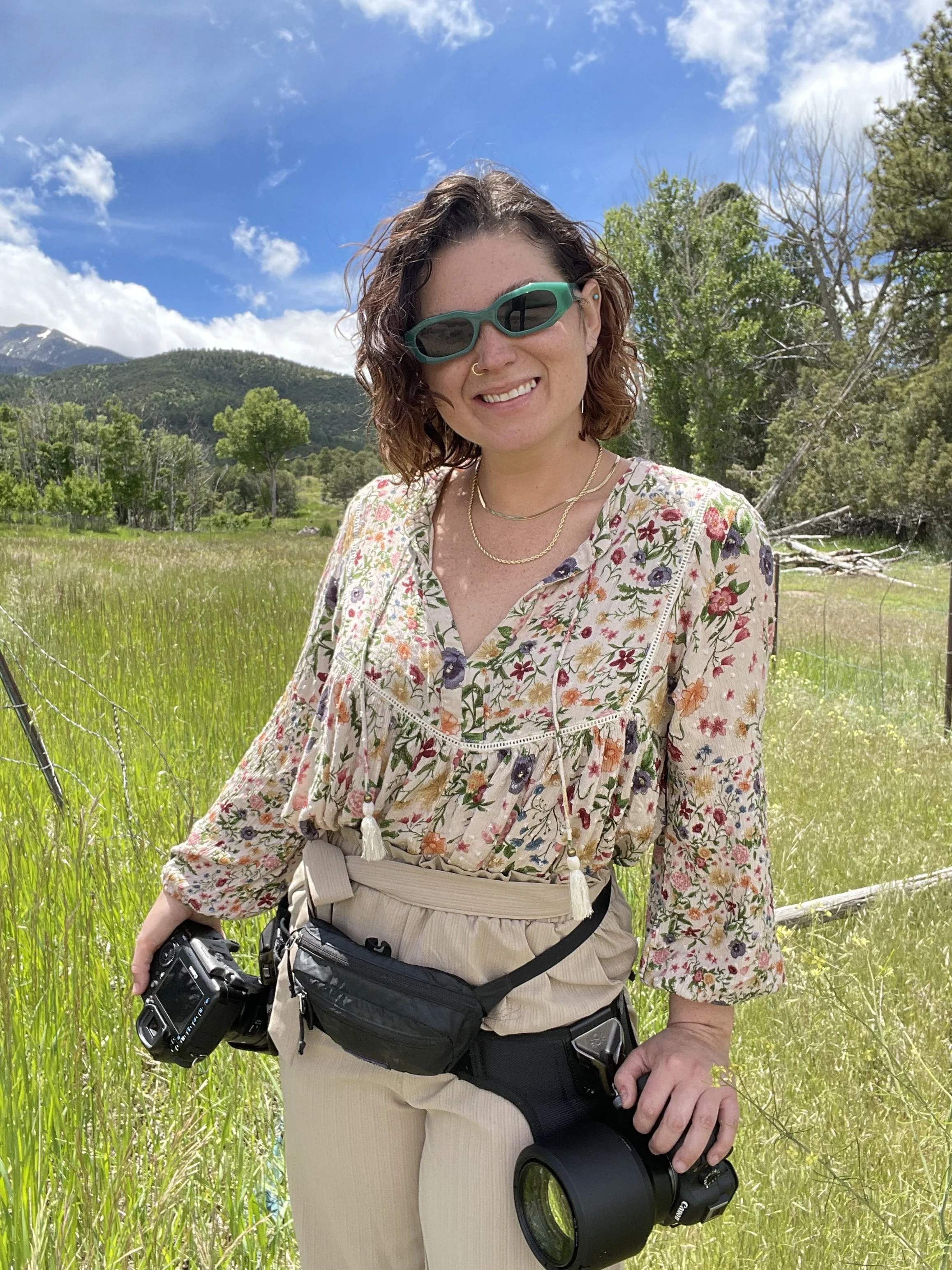 Ivy Bencheck- photographer, has two camera bodies on hip holster, ready for summer wedding in Colorado.