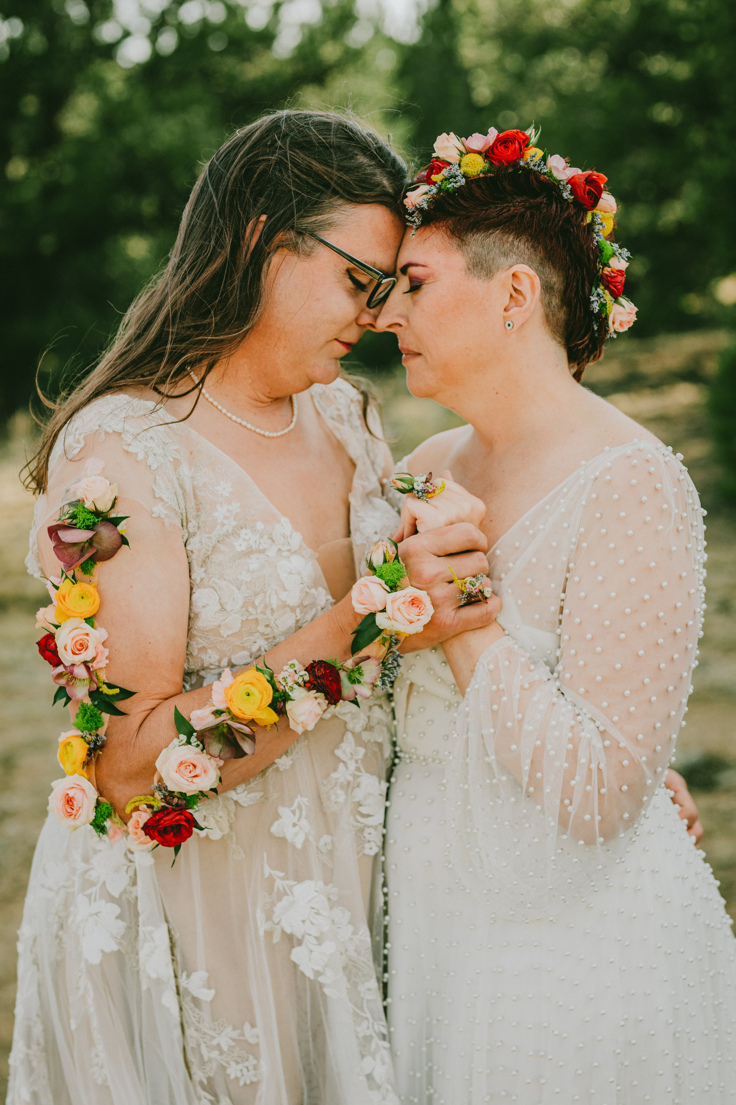 LGBTQIA+ couple covered in florals on their wedding day. Phytology Flowers, Salida, CO.