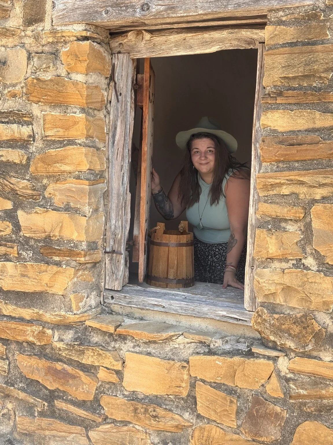 Kate the Brave smiling at Mission San José in San Antonio, Texas.