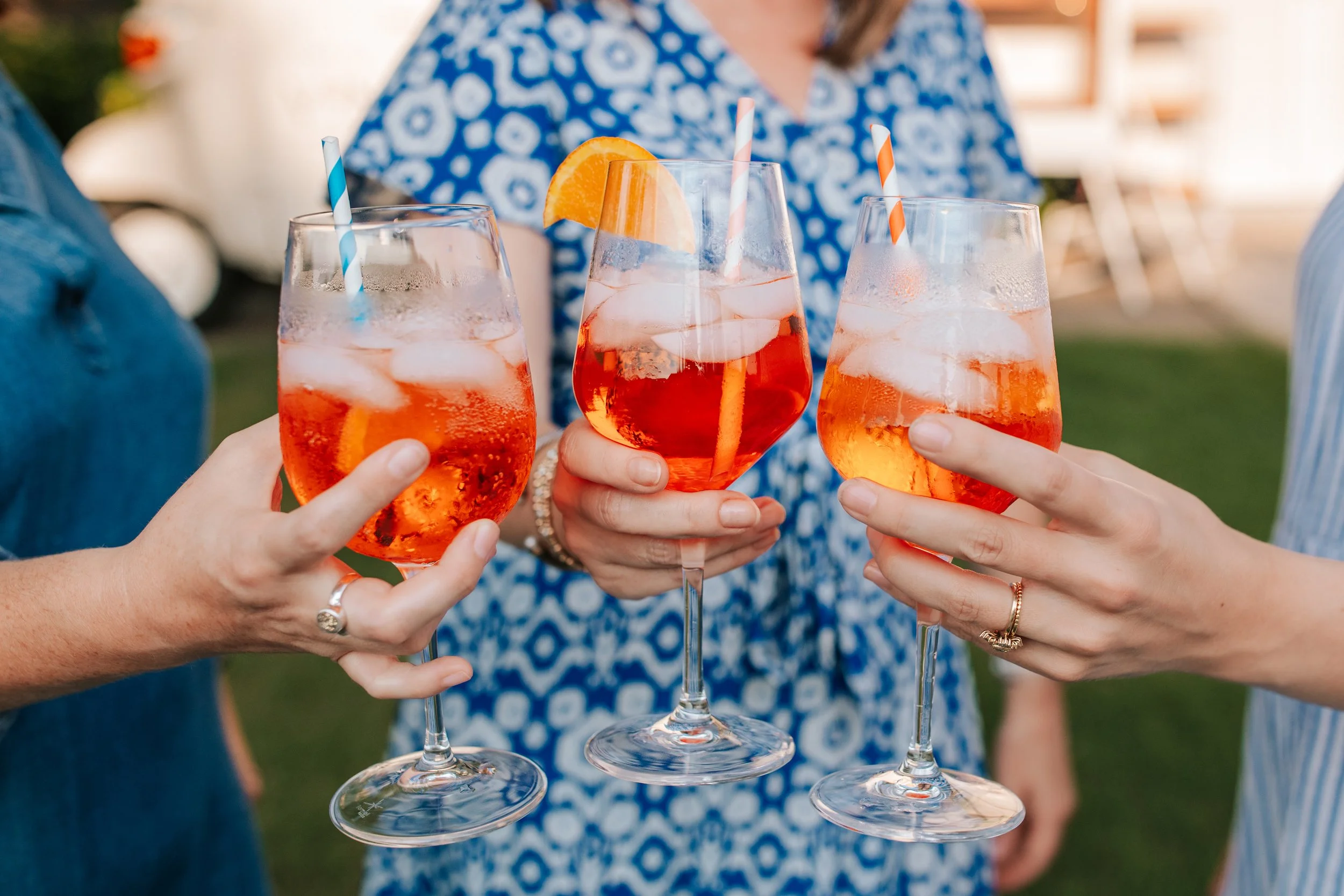 Bright and vibrant branding photo of 3 women clinking glasses for a mobile wine bar. 