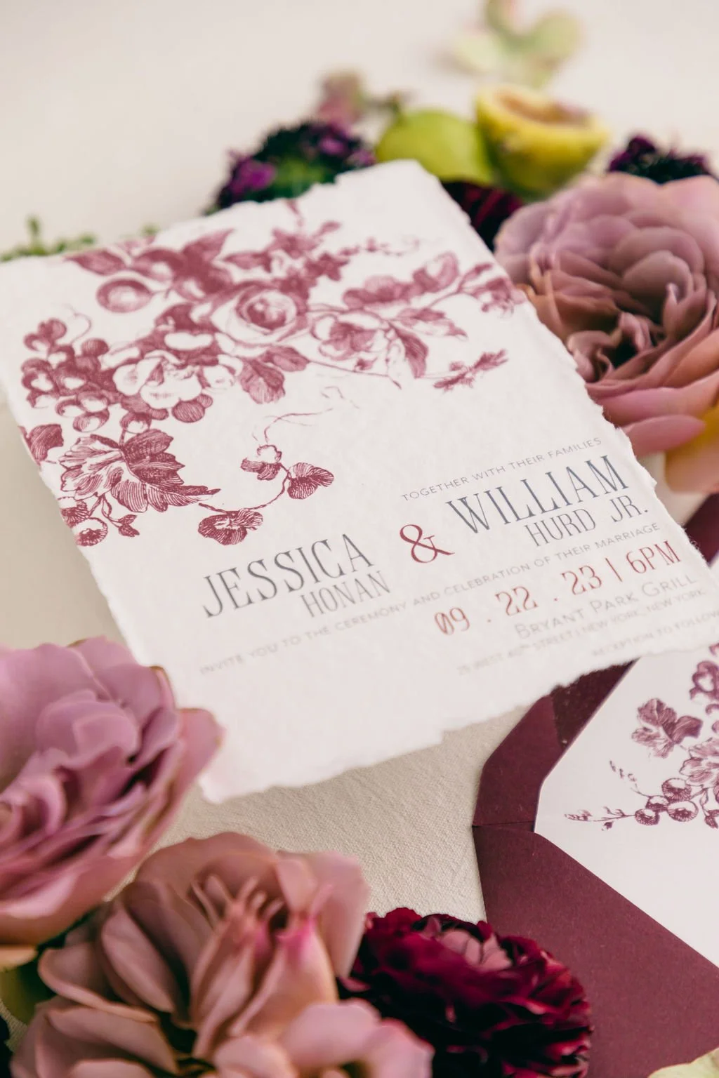 burgundy wedding invitation with oversize florals and natural deckle edges