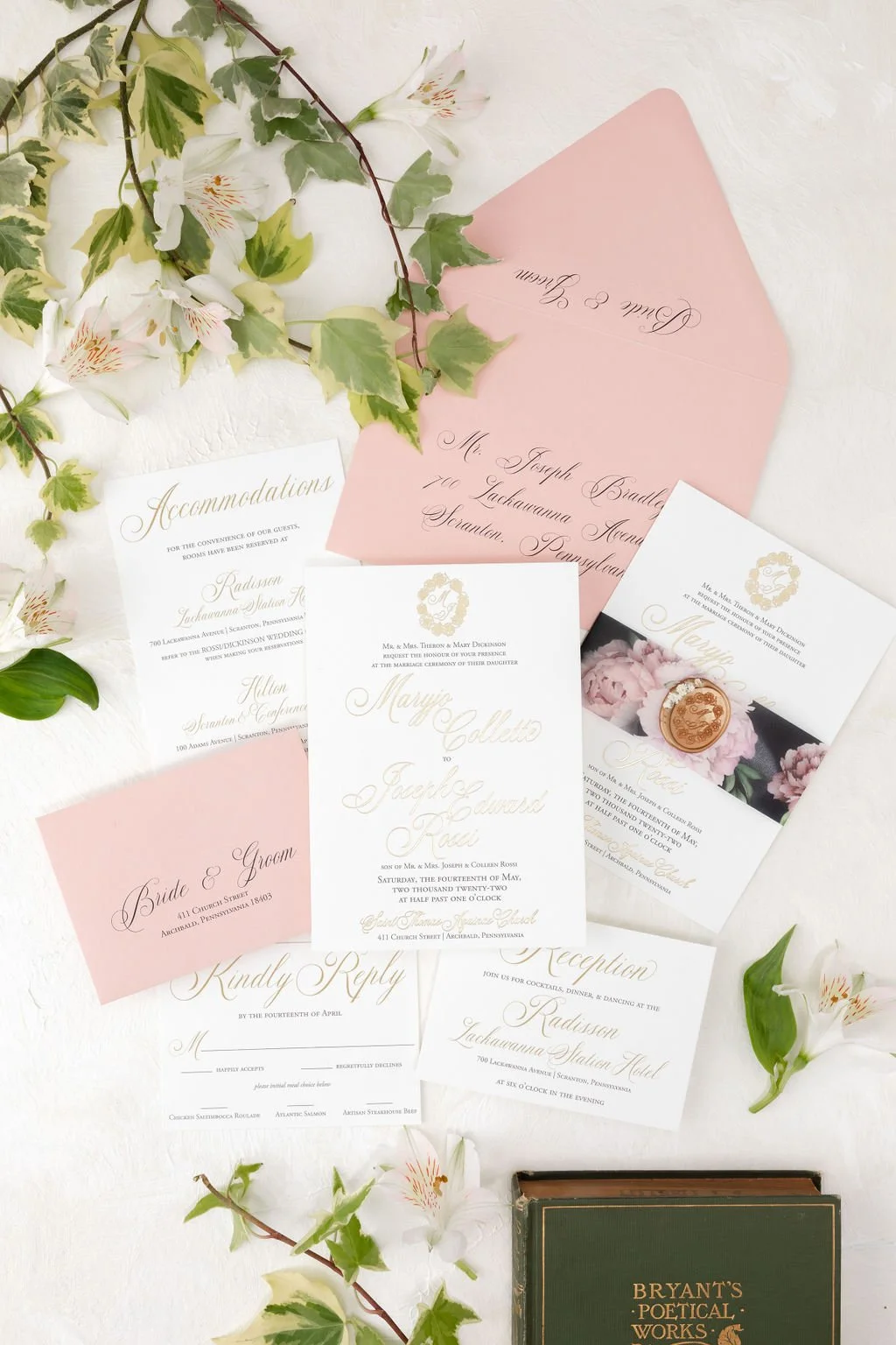 black, pink, and gold wedding invitation with gold foil and floral vellum band. Held together by a gold oval wax seal.
