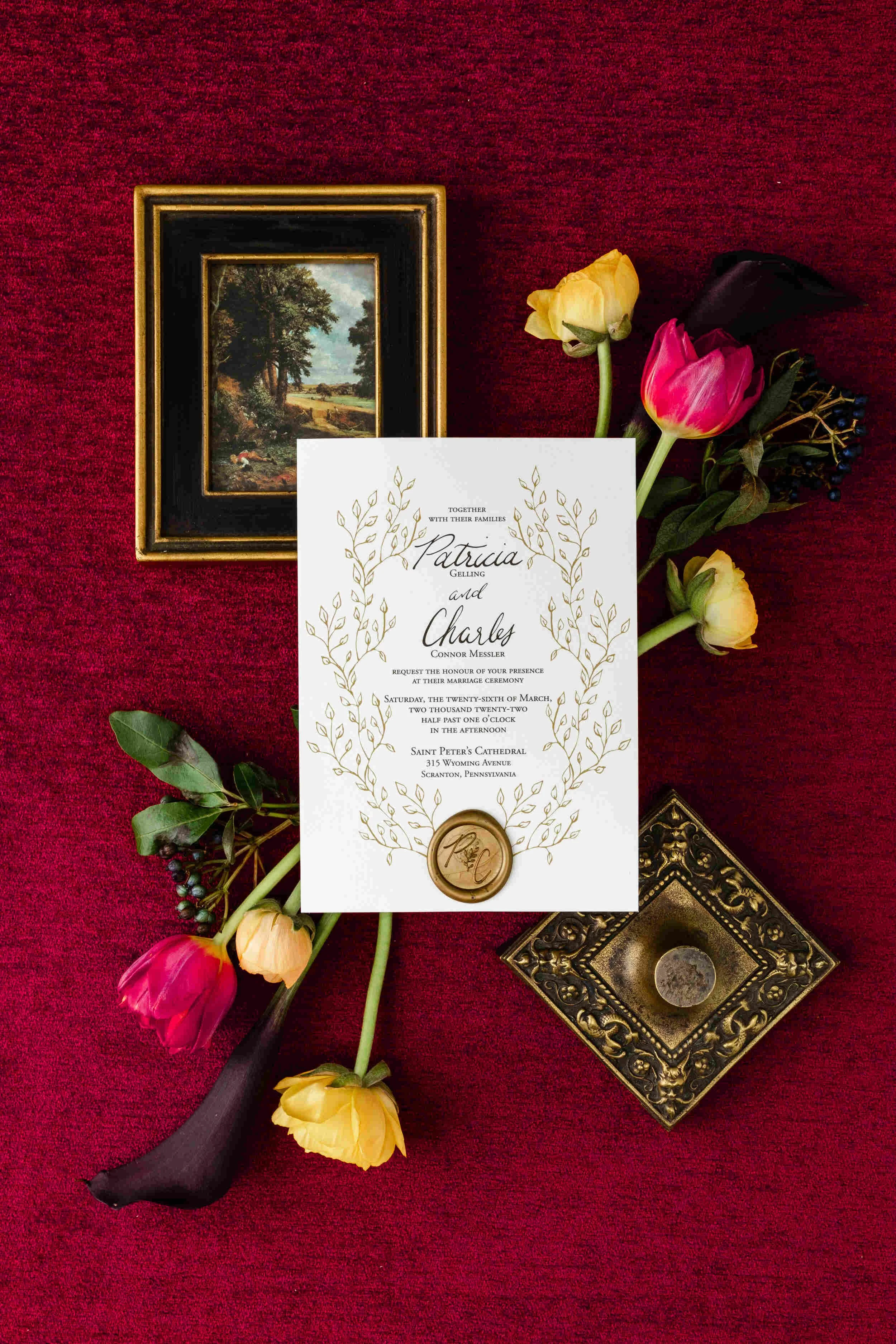 elegant garden wedding invitation featuring gold leaf frame and gold wax seal.