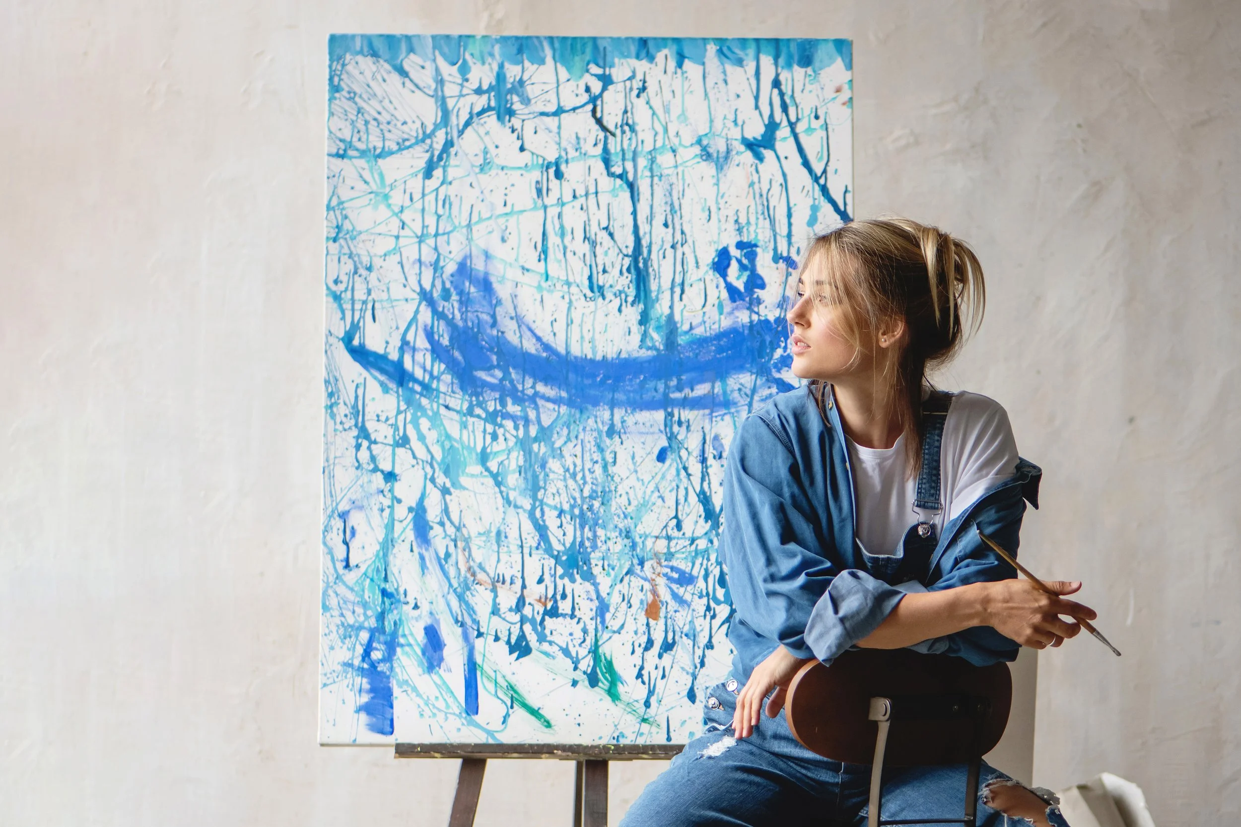 artist and abstract blue canvas