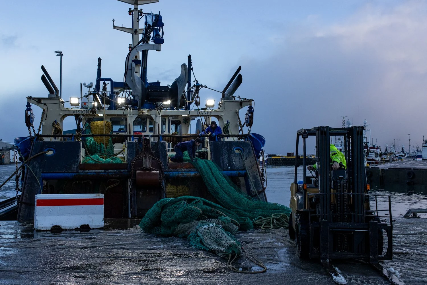 Fishermen dock a trawler that operates in the North Sea in Fraserburgh, a fishing town in northeastern Scotland.