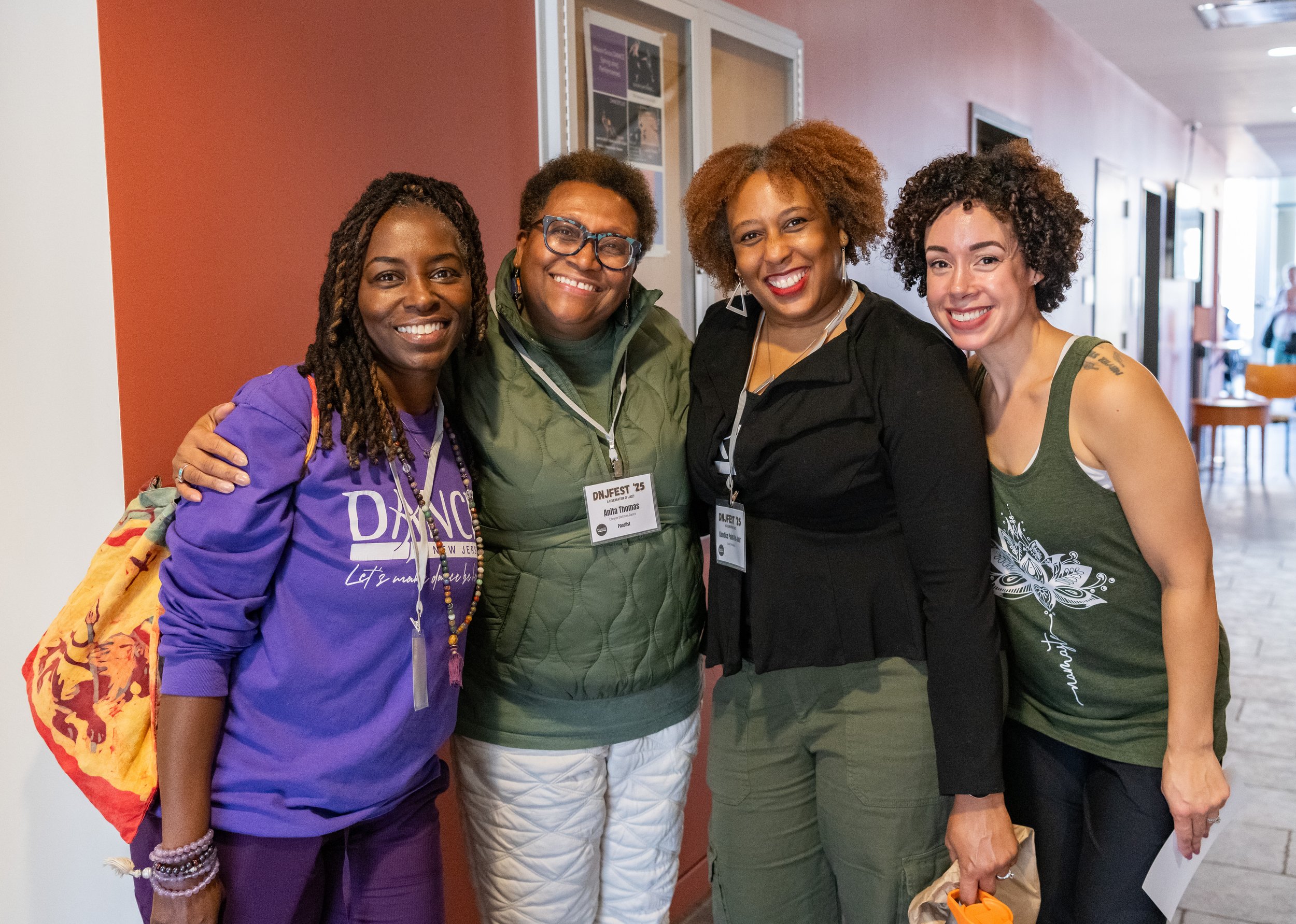 Four DNJ members posing and smiling