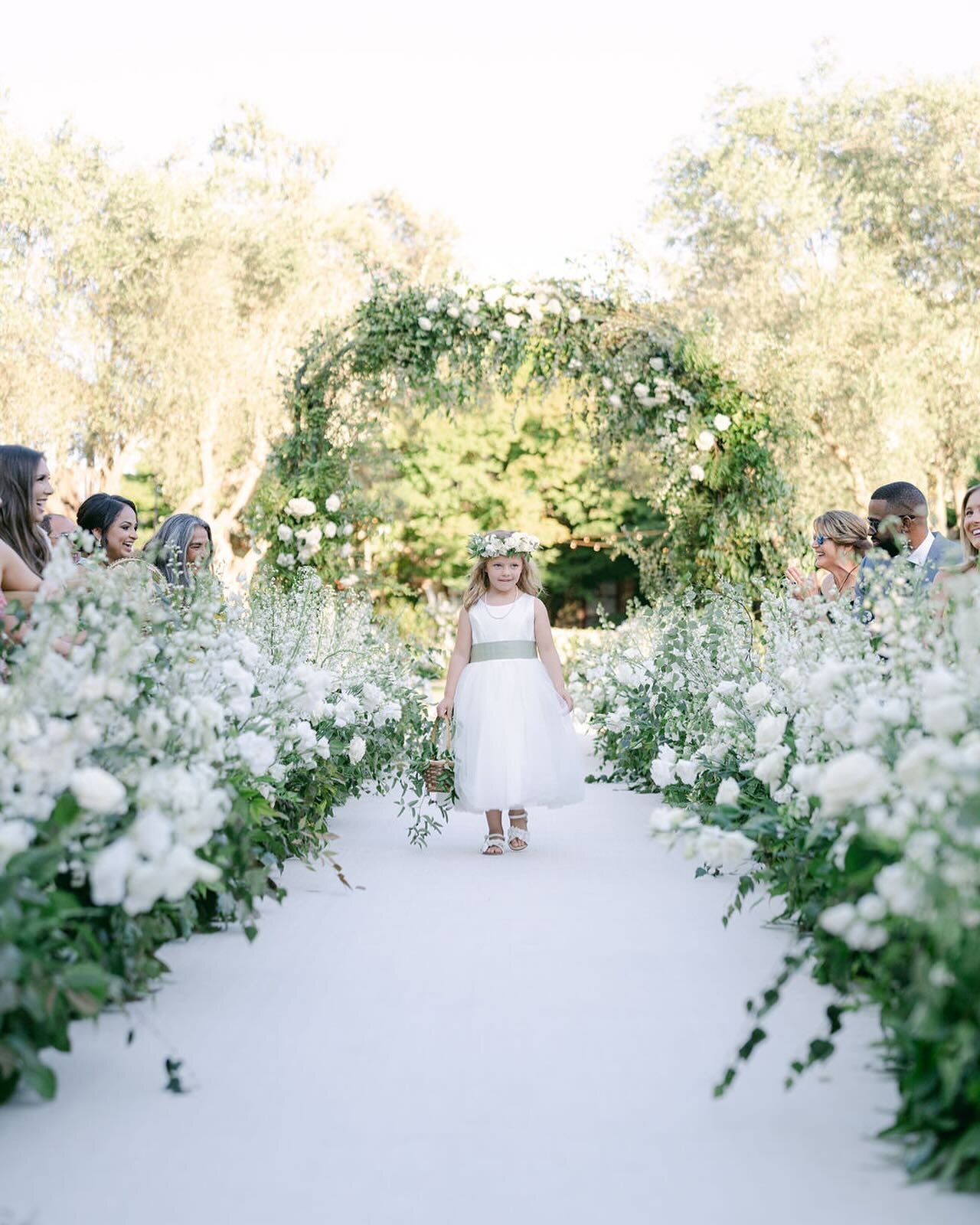 The sweetest flower girl matching perfectly with these aisle flowers