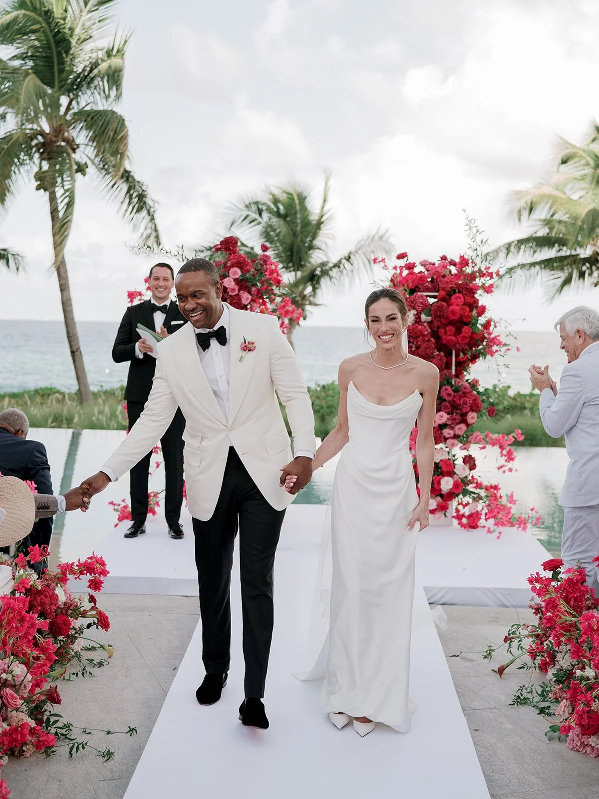 Luxury tropical pink & red outdoor  beach wedding at four seasons anguilla planned by lindsay buzaid L. Scott Events