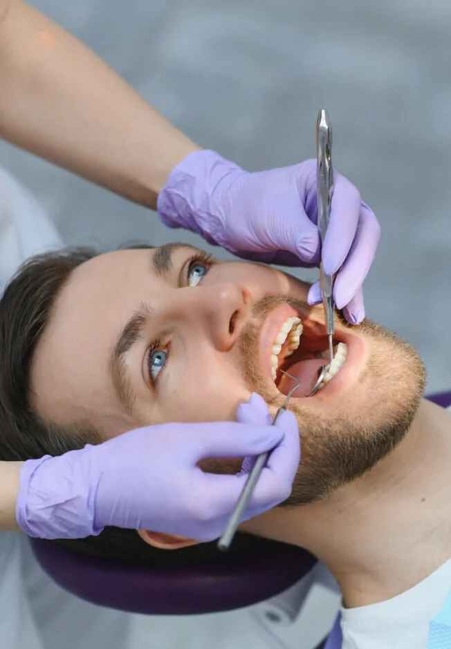 General dentist examining a patient’s teeth at a dental clinic in Dubai.