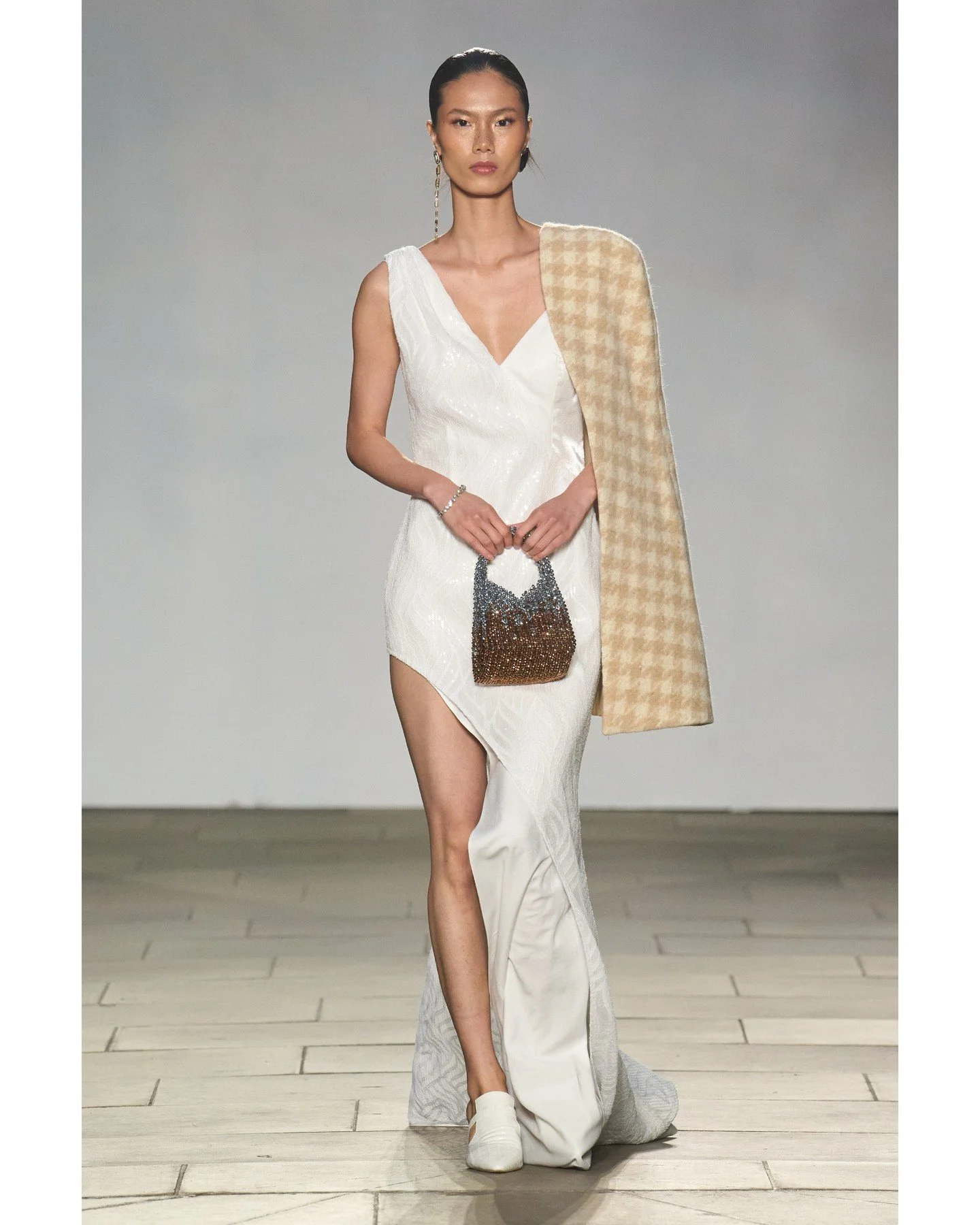 Dramatic cut-outs and asymmetrical draping techniques gave movement to traditionally structured forms.