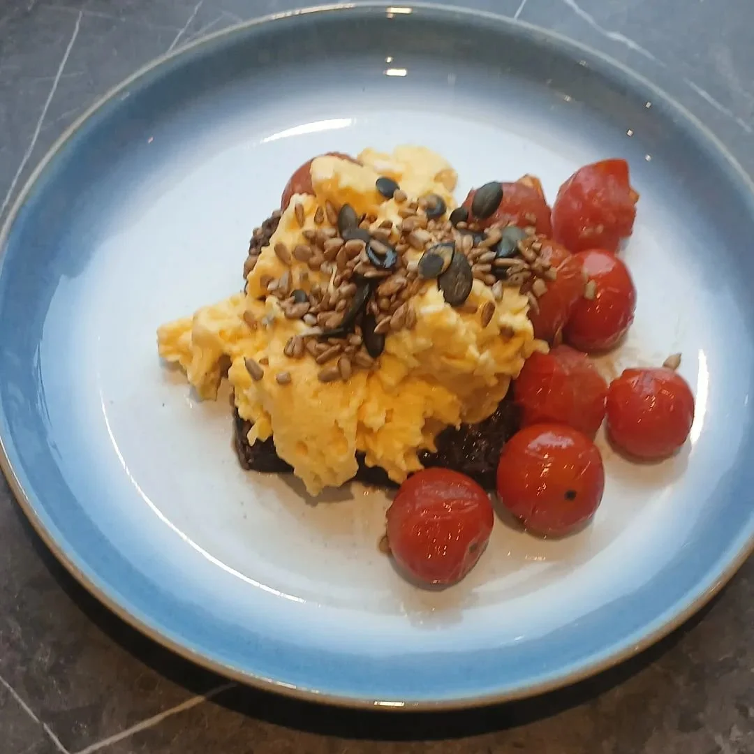 I'm back in my kitchen today and focused on nutrition. 

Oven reasted cherry tomatoes, scrambled eggs on rye. Topped with soya roasted pumpkin and sunflower seeds. 

609kcals 
23g carbs 
47g fats 
27g protein