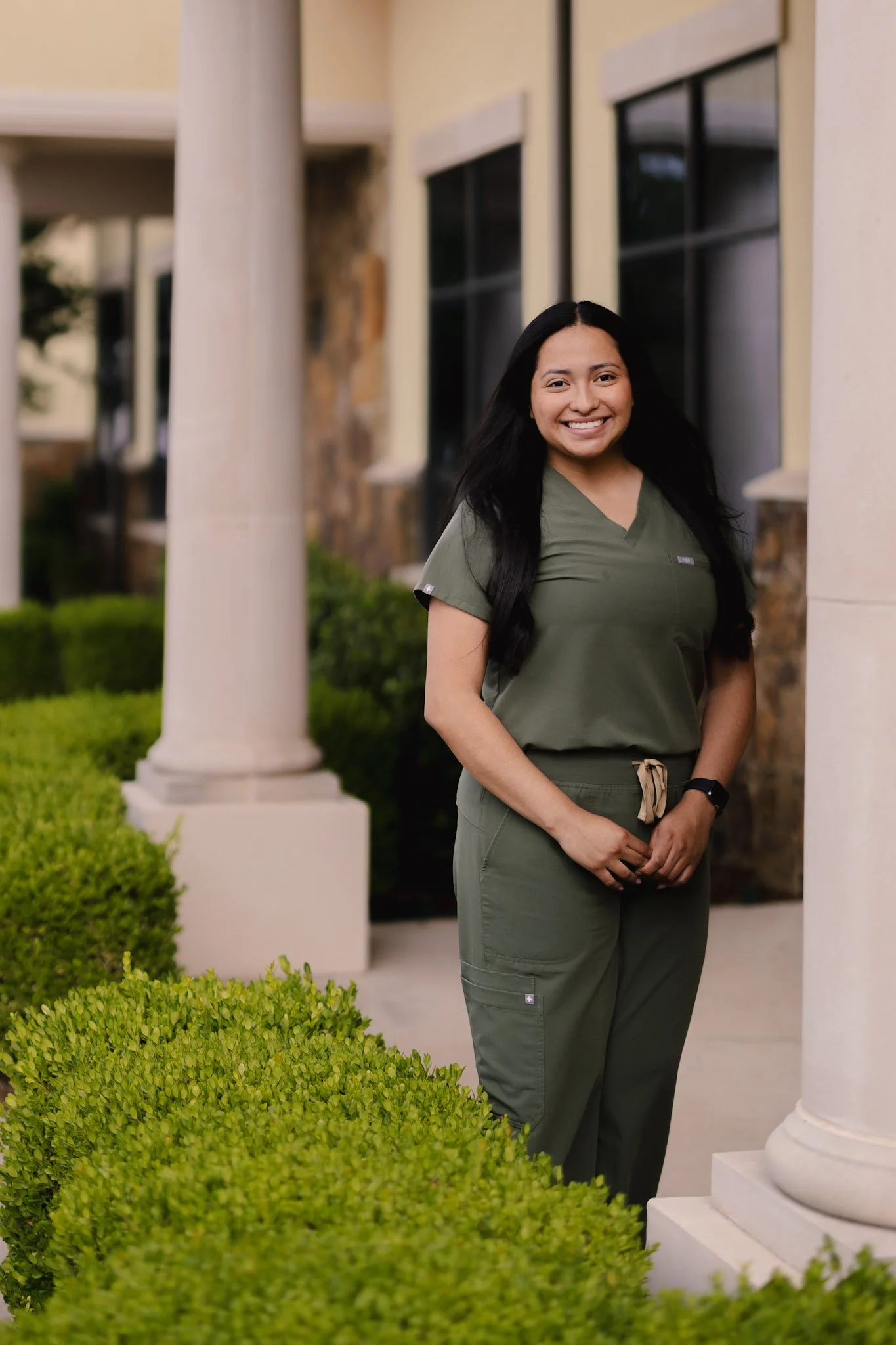 Dental assistant at Smiles of North Dallas dental office in Garland, TX in Richardson, TX wearing green FIGS scrubs.