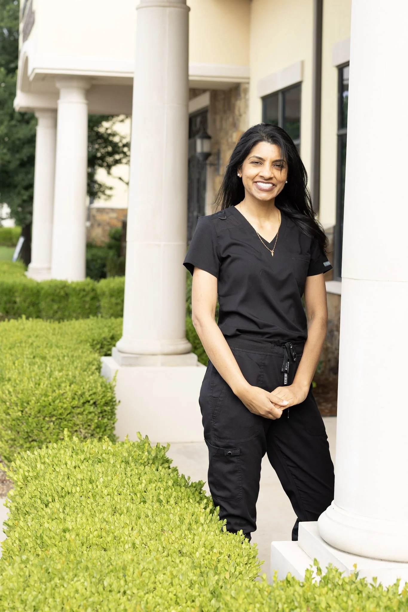 Dental hygienist at Smiles of North Dallas dental office in Sachse, TX in Dallas, TX wearing black Cherokee scrubs.