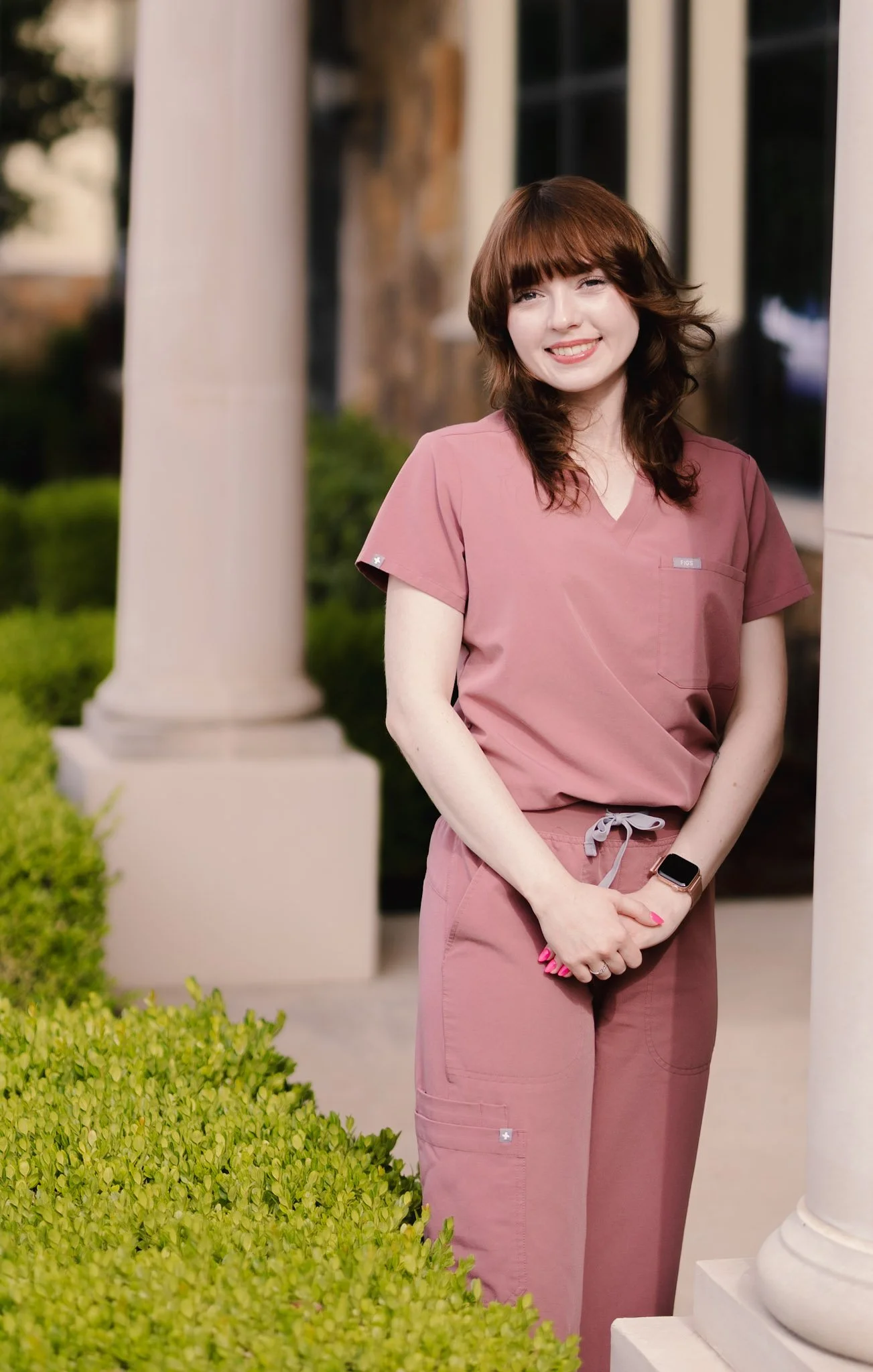 Front office staff member at Smiles of North Dallas dental office in Wylie, TX in Dallas, TX wearing pink FIGS scrubs.