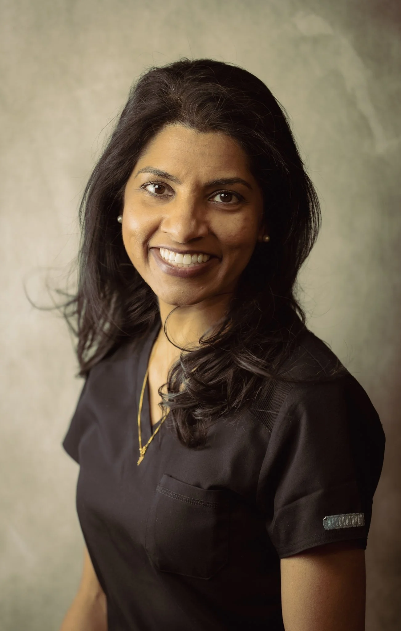 Dental hygienist at Smiles of North Dallas dental office in Garland, TX in Dallas, TX wearing black Cherokee scrubs.