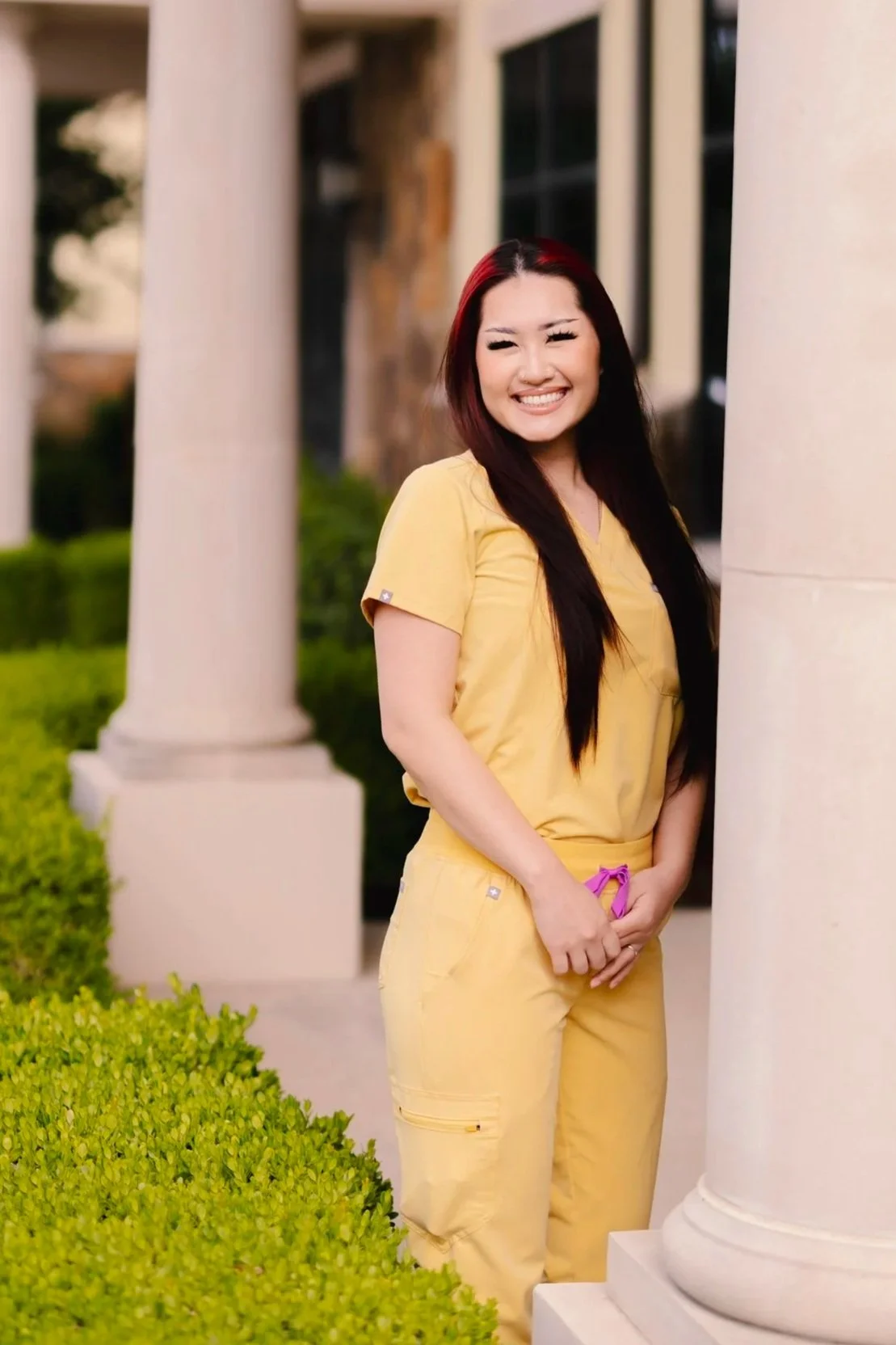 Dental assistant at Smiles of North Dallas dental office in Richardson, TX in Dallas, TX wearing yellow FIGS scrubs.