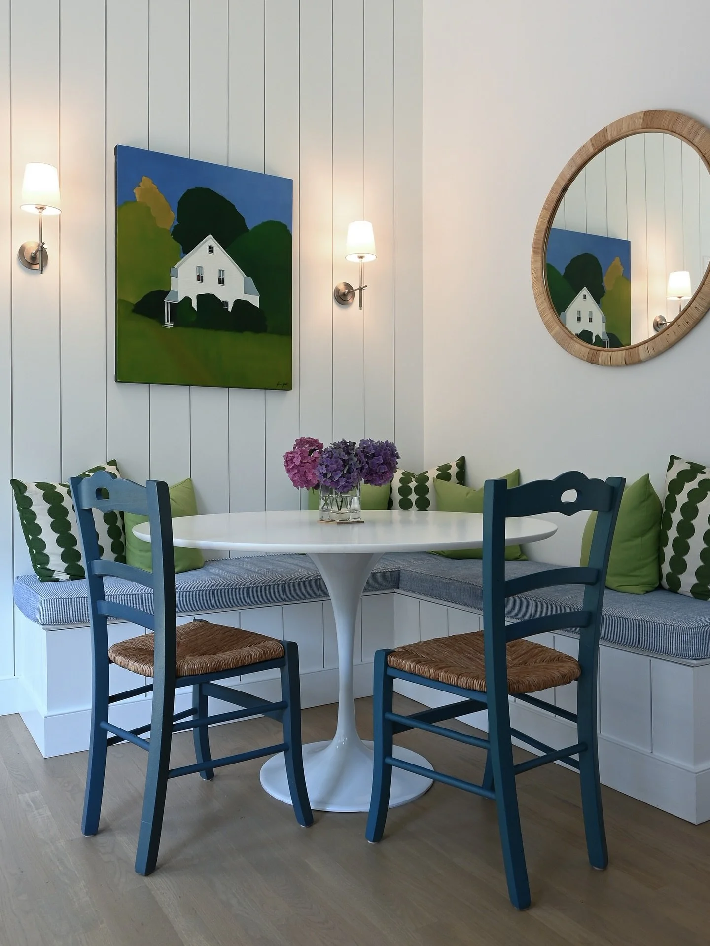 A bright and lively kitchen with breakfast nook designed for an artist&rsquo;s summer cottage retreat. How fun are the colorful custom cushions!