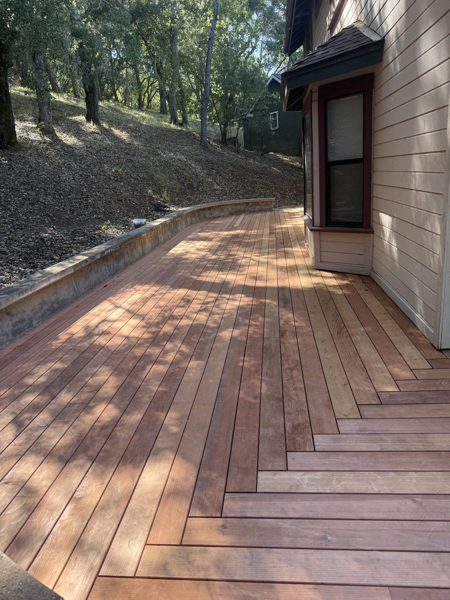 Custom wood deck beside a home with hillside oak trees in San Luis Obispo County