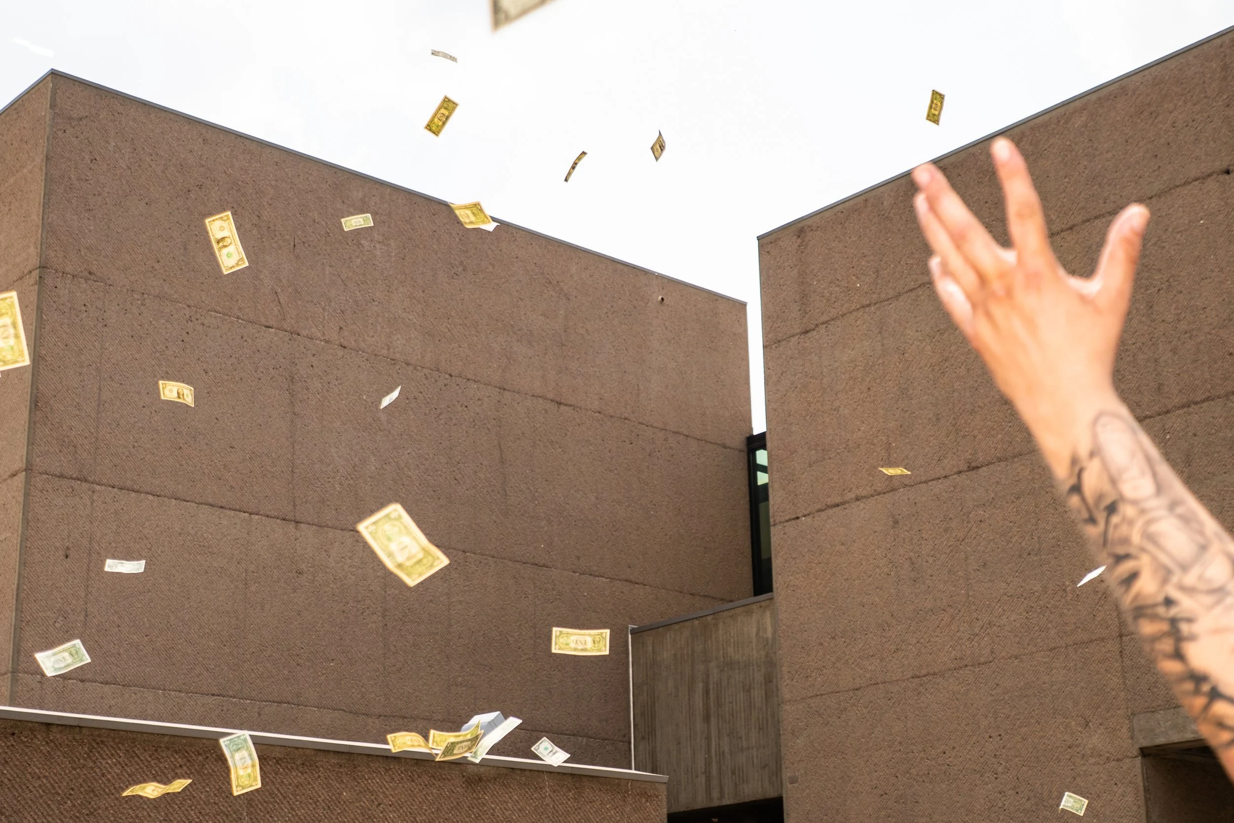 Once 'Shmoo at Sunset', a statue by artist and skater Mark Gonzales was revealed, wads of cash were thrown into the air -- leaving the crowd scrambling for fistfulls of dollars. June 7 2025, Syracuse NY. 